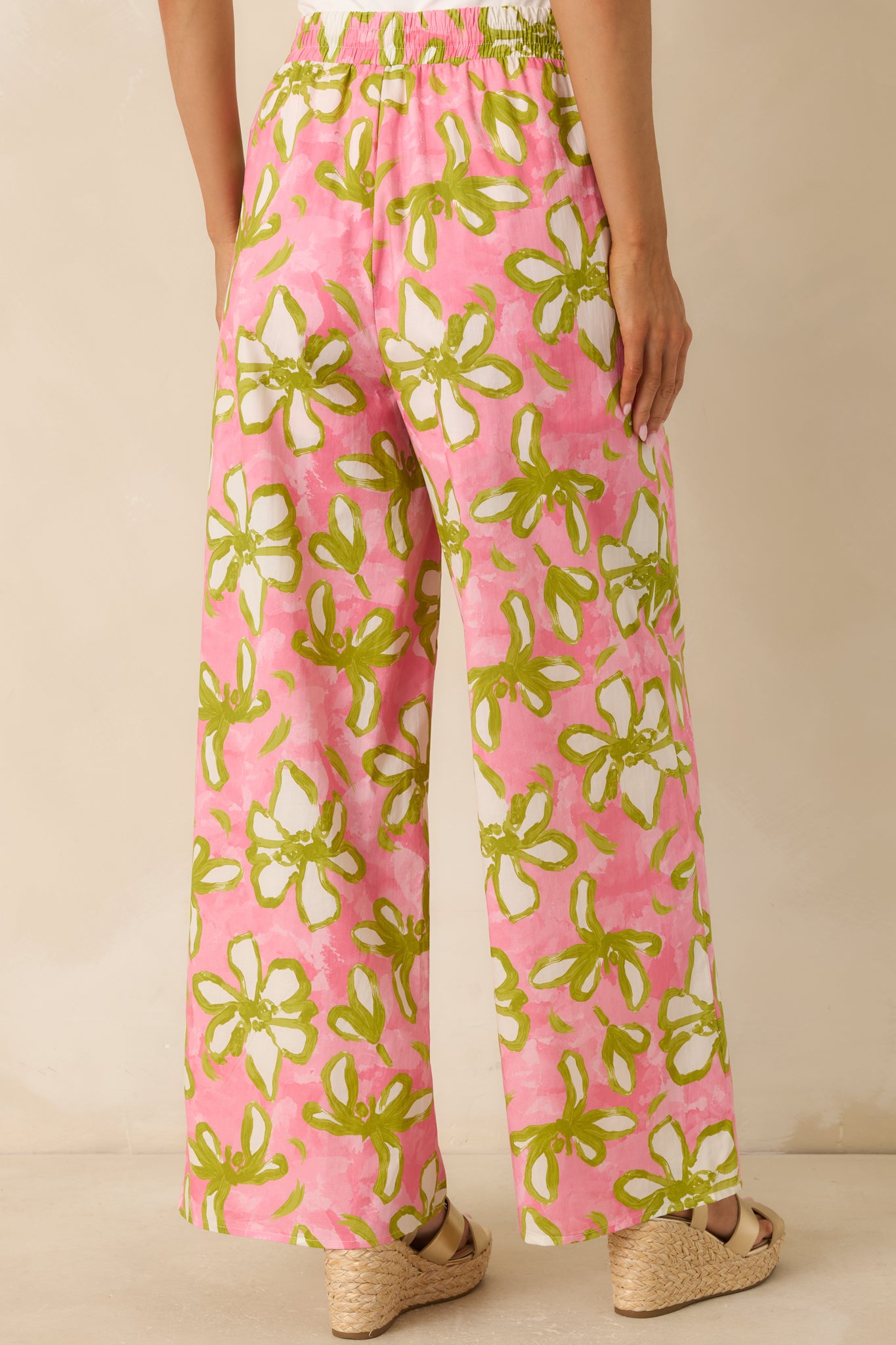 Back view of the floral wide-leg pants featuring an elastic waistband, relaxed silhouette, and continuous bold print design.