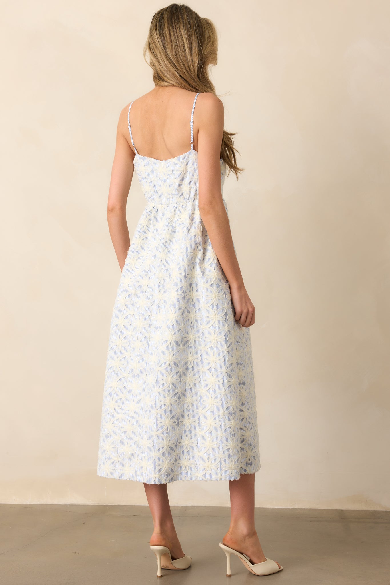  Back view of the maxi dress, featuring the hidden back zipper and adjustable spaghetti straps, with the 3D floral appliqués continuing throughout the design.
