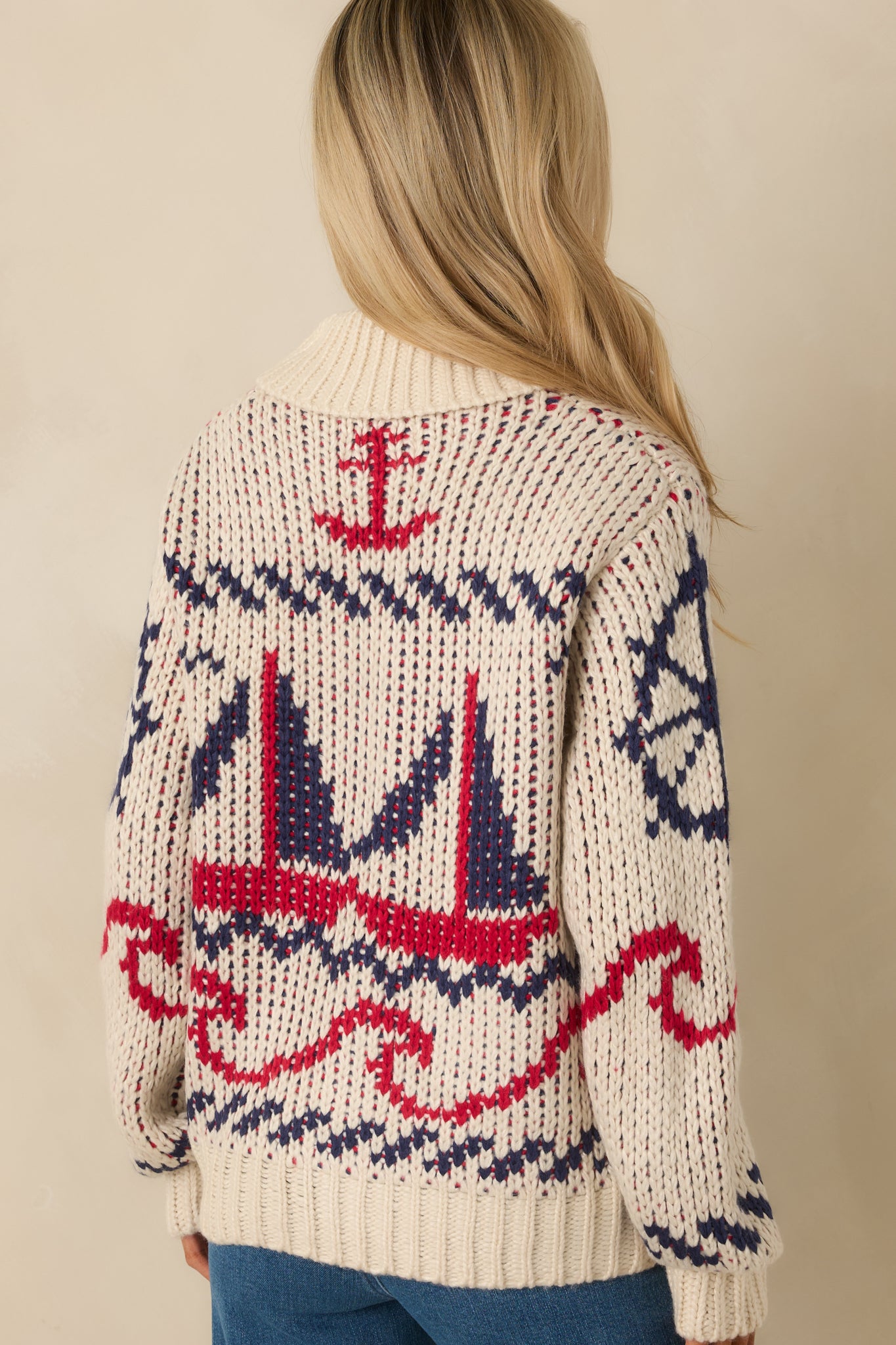 Another back view of the ivory multi-knit jacket featuring its nautical motifs. 