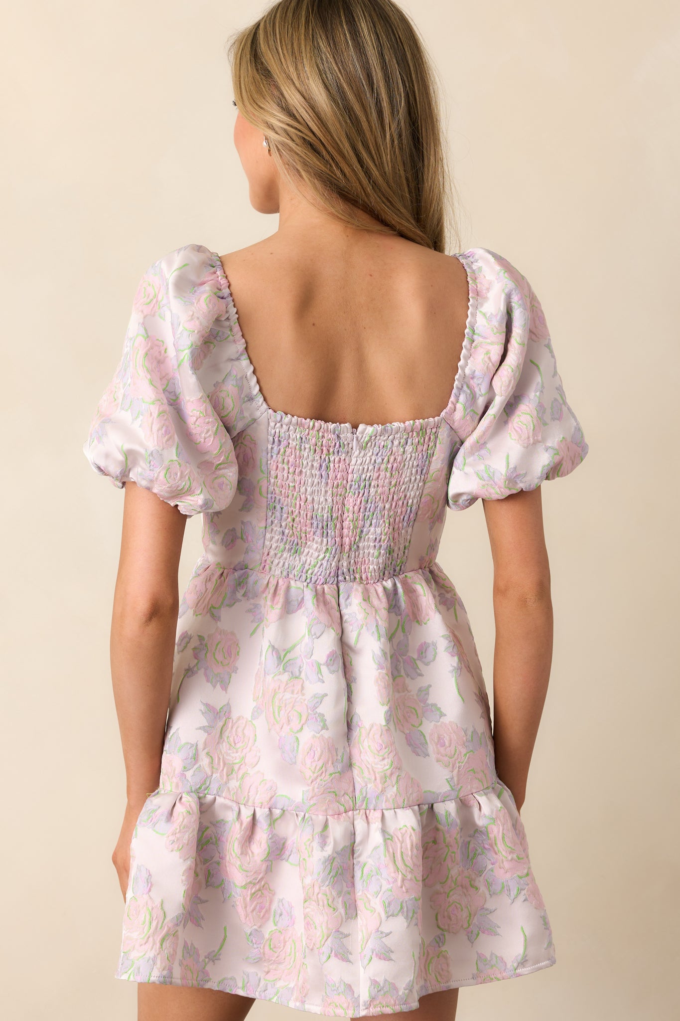 A complete back view of the dress, featuring the smocked panel, hidden zipper closure, and continuation of the floral jacquard design.