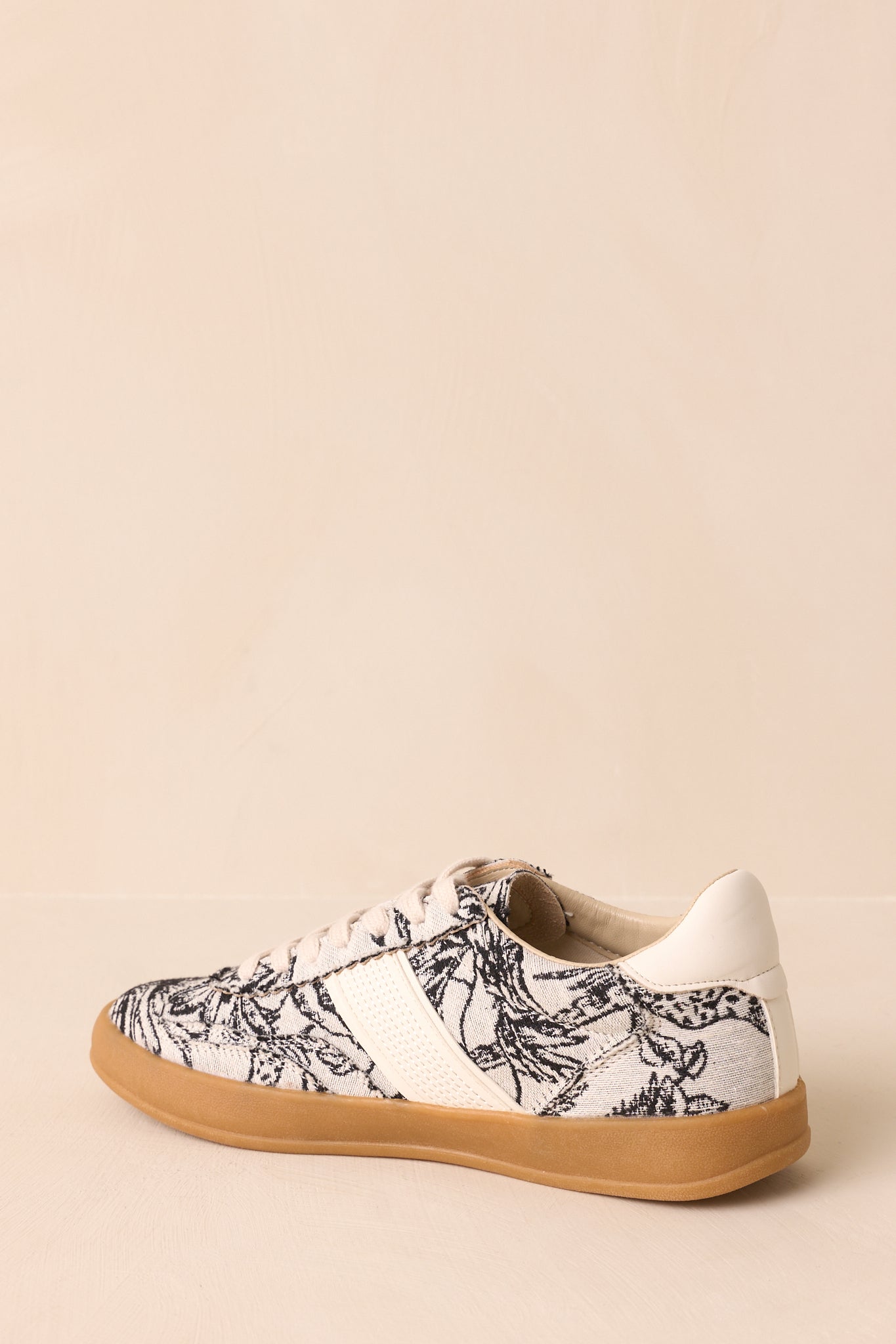 Back view of the sneakers showing heel shape, floral print canvas, and gum rubber sole.