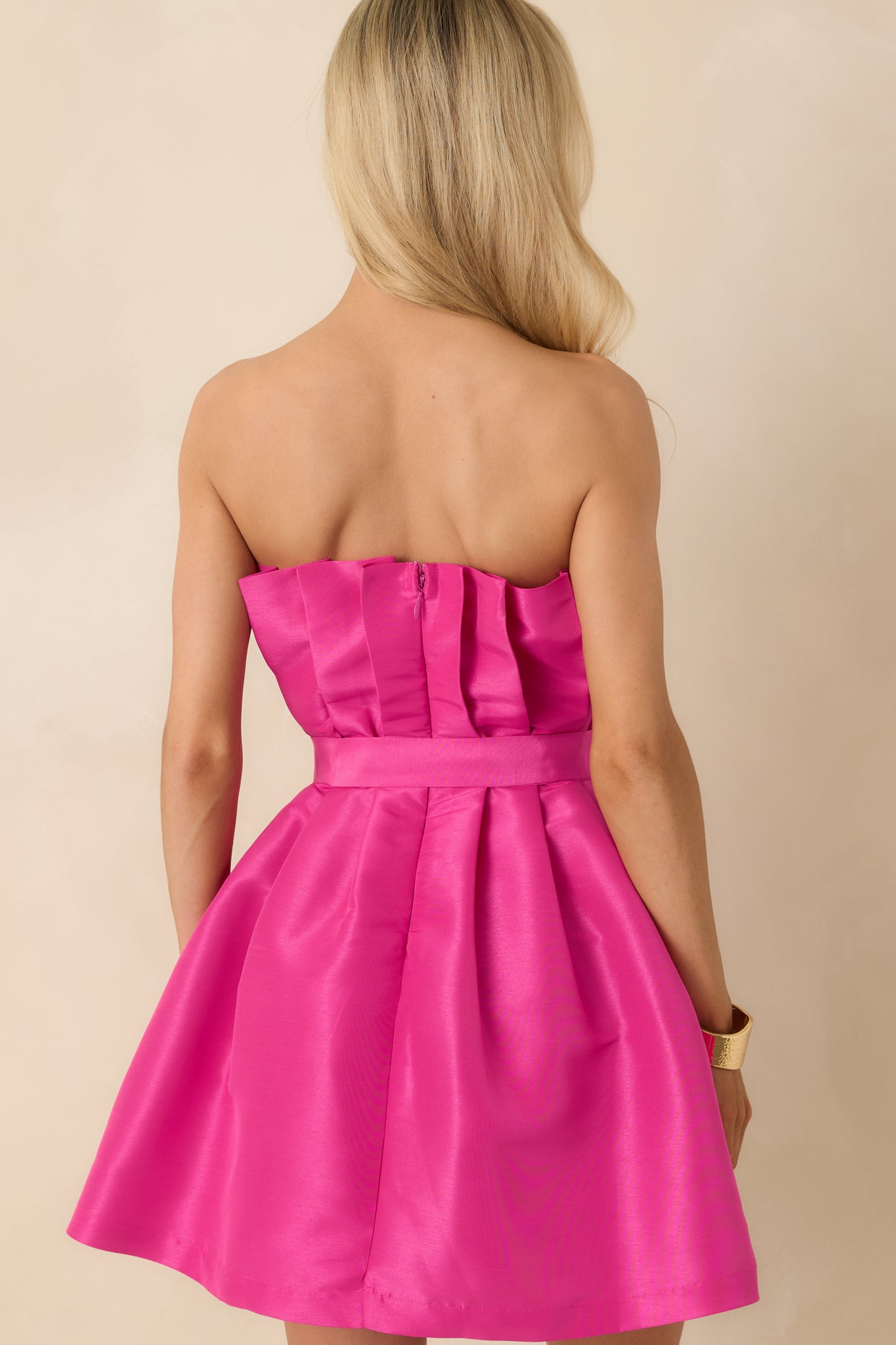 Rear of the fuchsia mini dress featuring a concealed back zipper and softly flared hem for seamless fit and comfort.