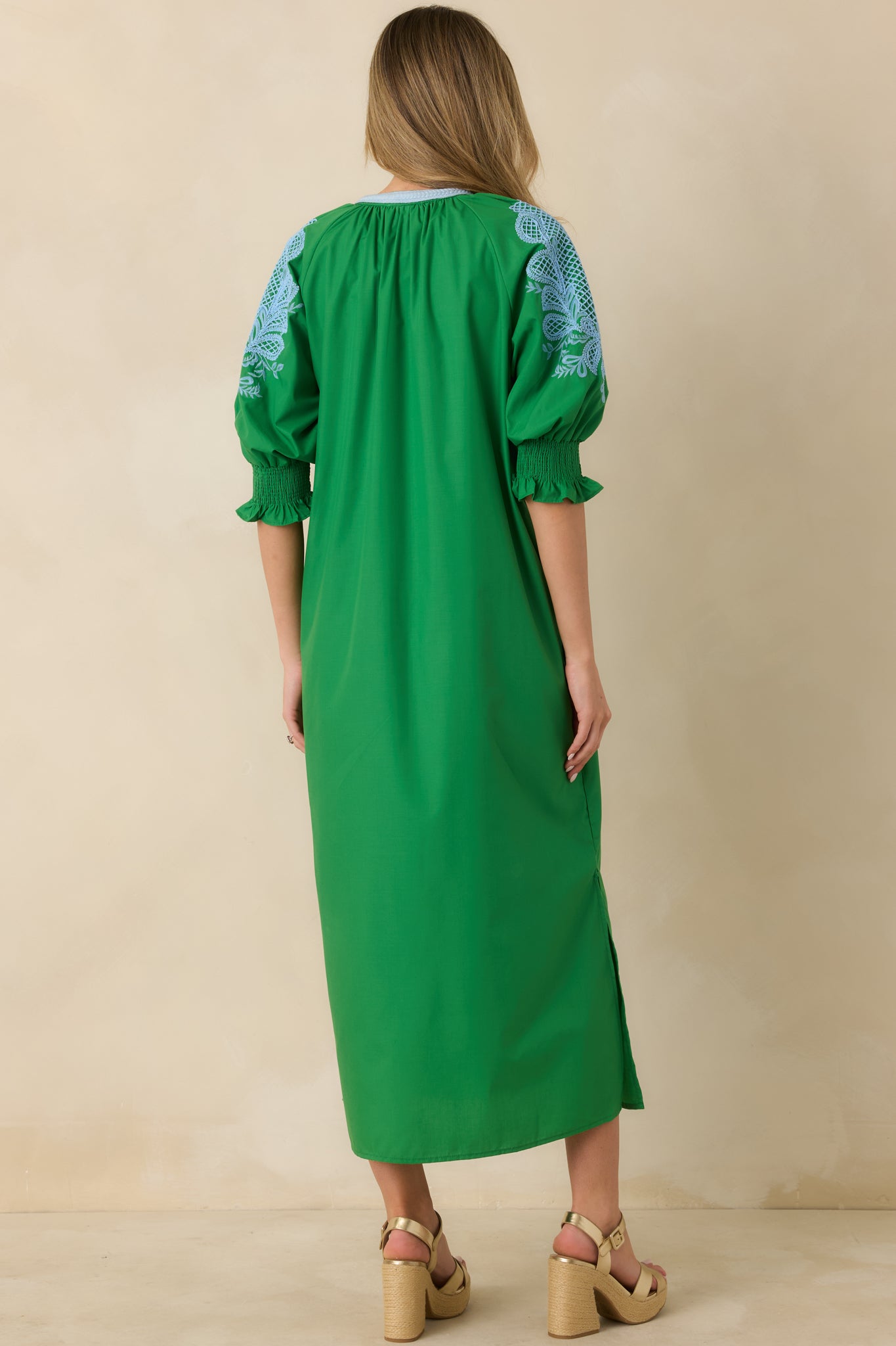 Back view of the green maxi dress showing the clean woven fabric and relaxed maxi silhouette.