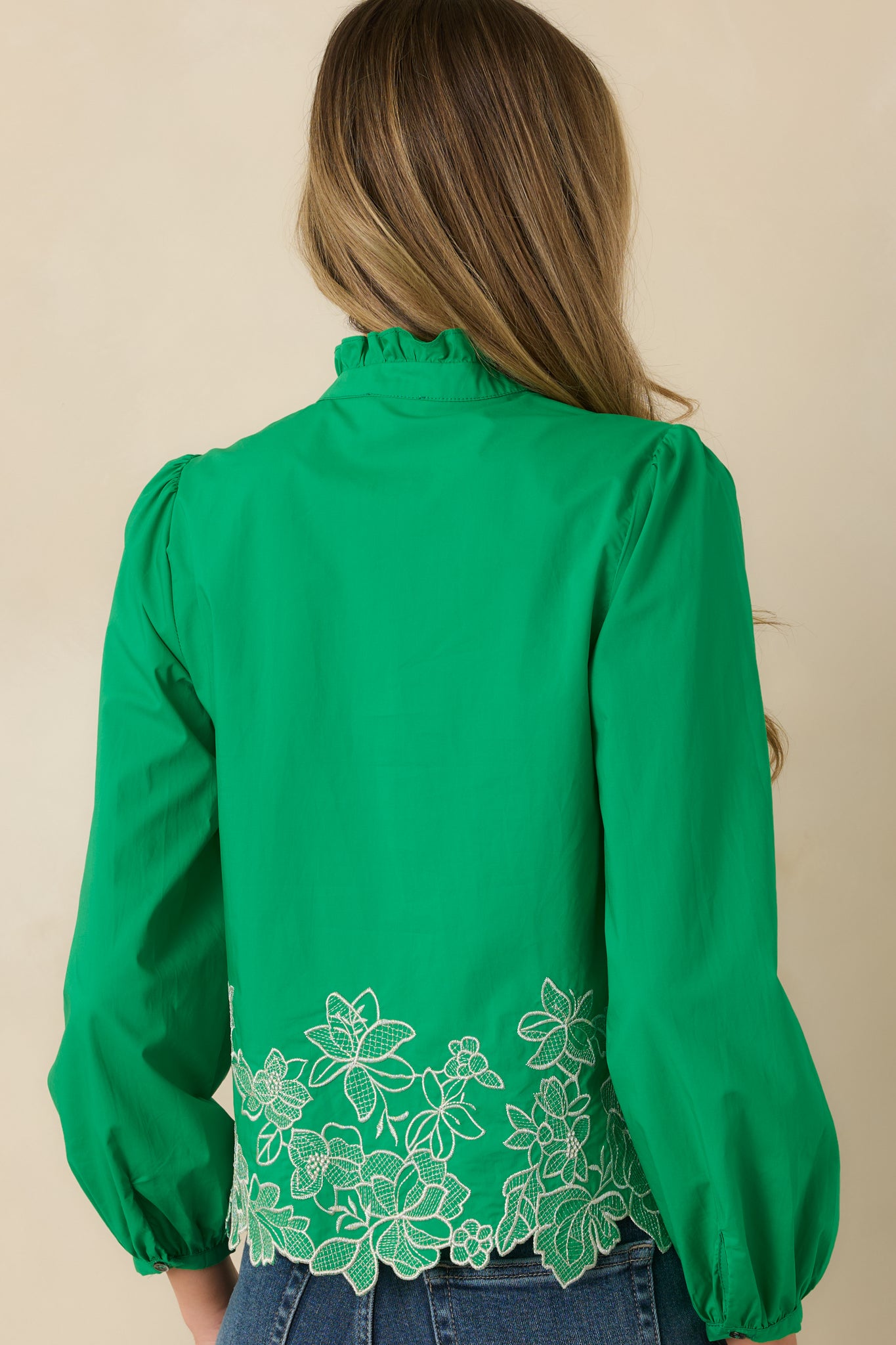 Back view of the green long sleeve top featuring a relaxed straight fit and subtle puff sleeve volume.