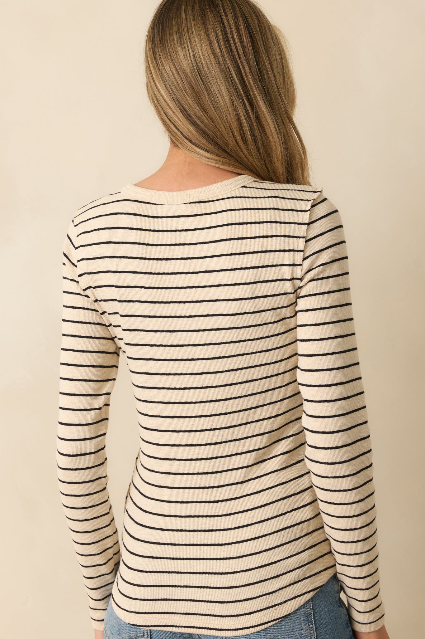 Back view of the Henley top showing the fitted silhouette, long sleeves, and continuous striped pattern.