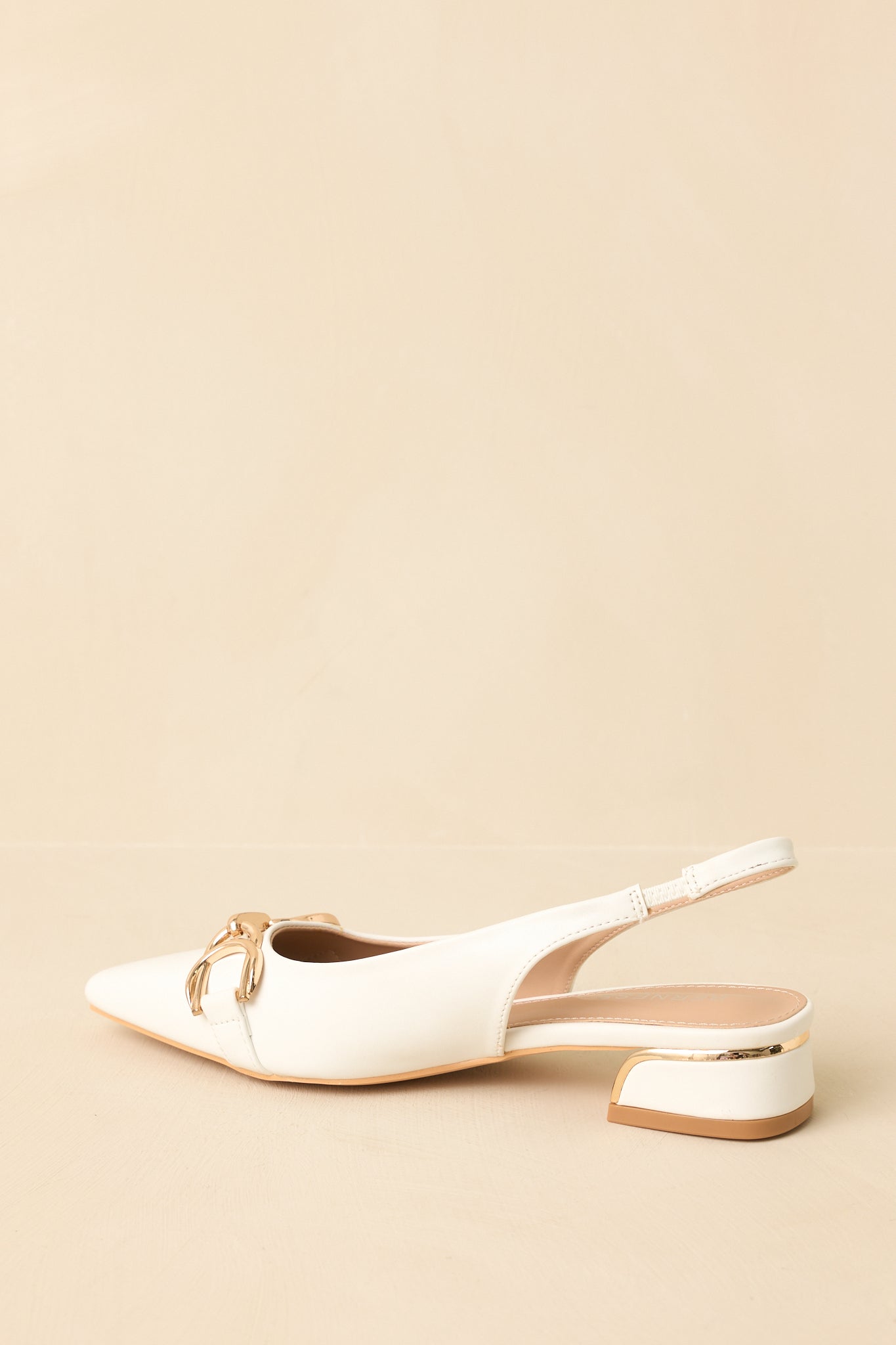Back view of the white slingback flats highlighting the secure slingback strap and clean heel line.