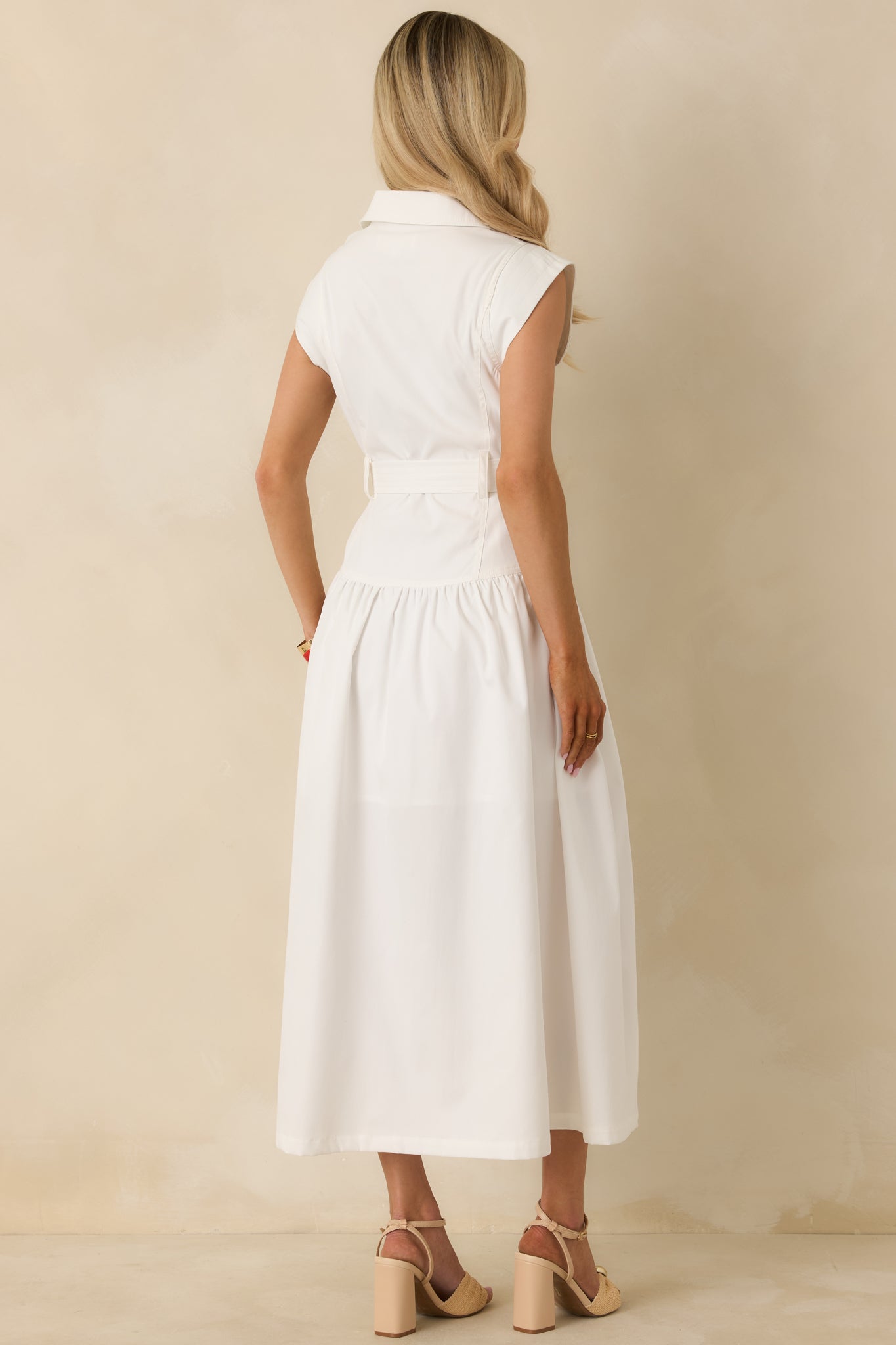 Back view of the white sleeveless maxi dress highlighting the gathered skirt, cinched waist, and full-length silhouette.