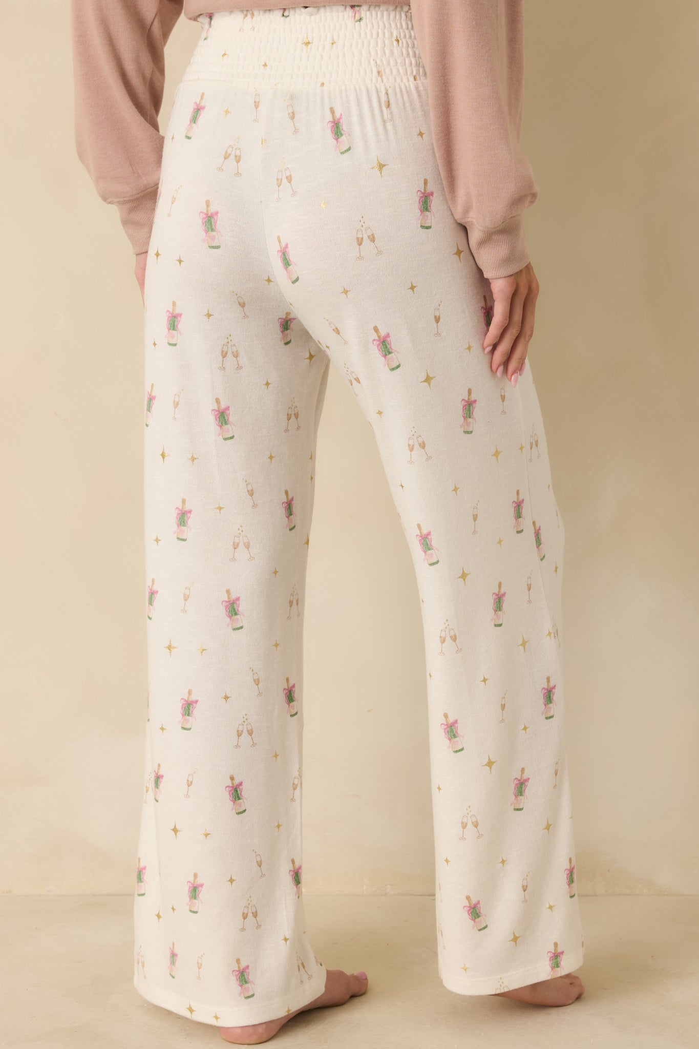 Back view of the ivory lounge pants showing wide-leg drape and clean back finish.