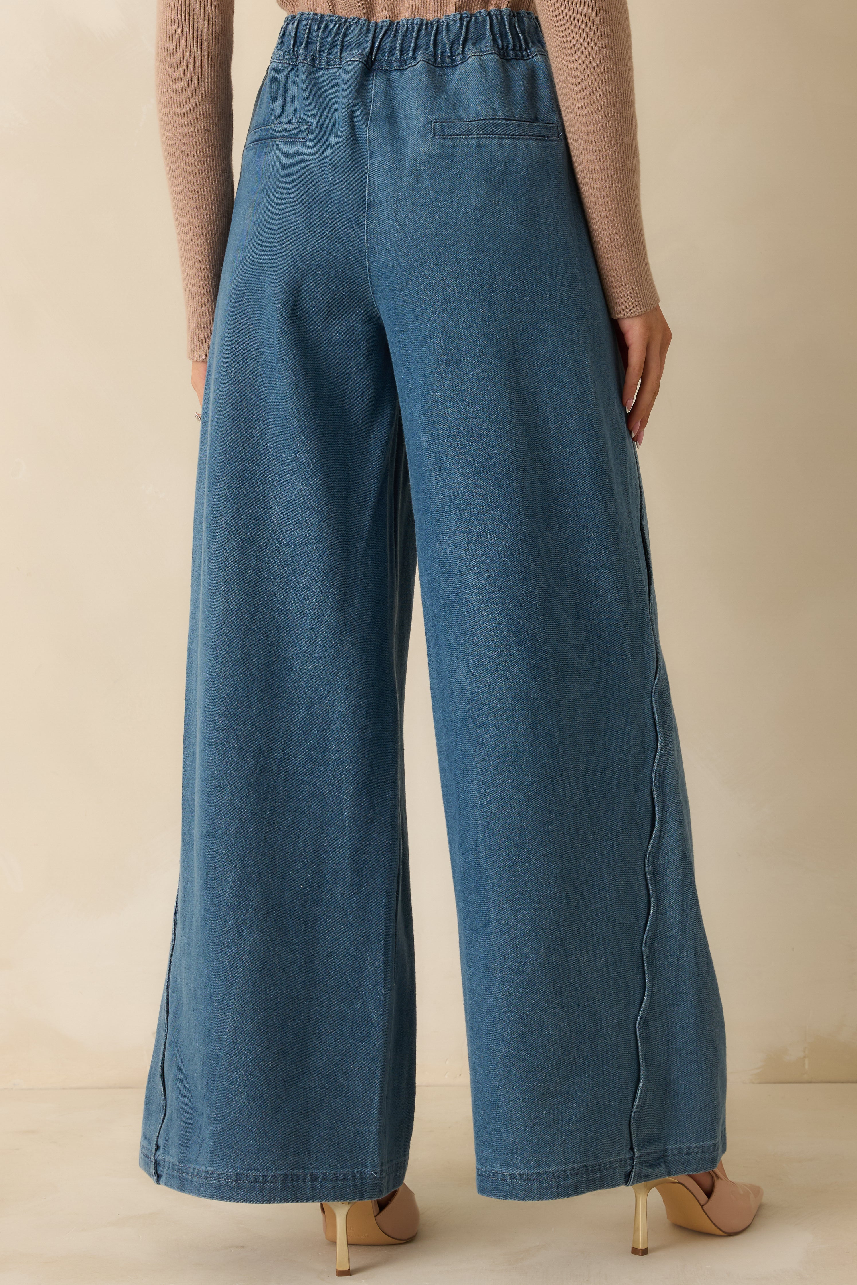 Back view of the jeans highlighting the back pockets and high rise waistband.