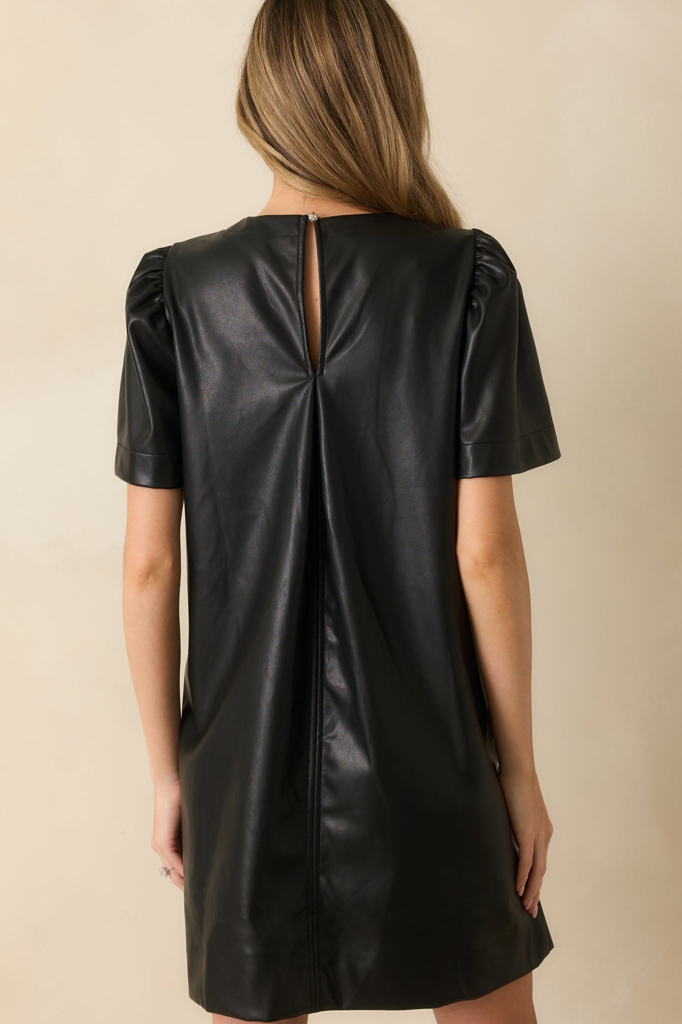 Rear view featuring the keyhole button closure and inverted pleat that adds movement.