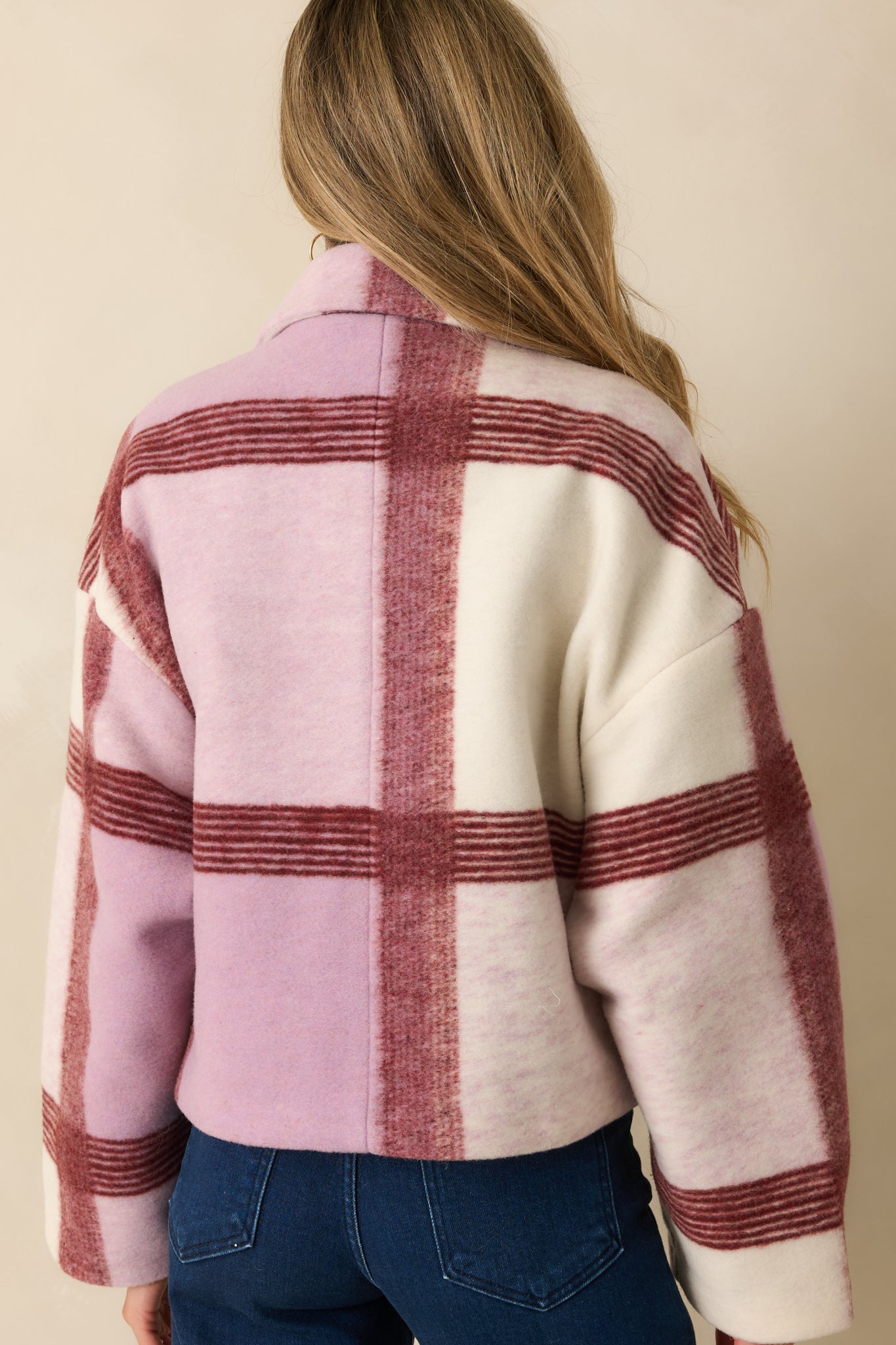 Rear view of the lilac plaid jacket displaying the full check pattern and boxy, relaxed silhouette.