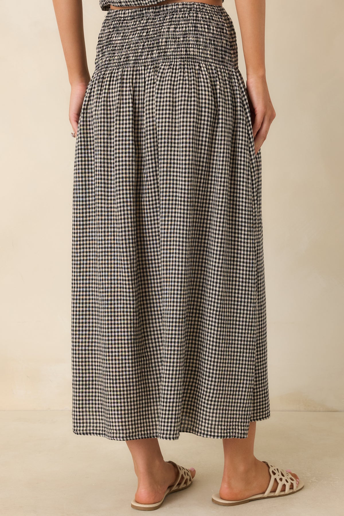 Back view of the flowing linen blend maxi skirt featuring a full draped silhouette.