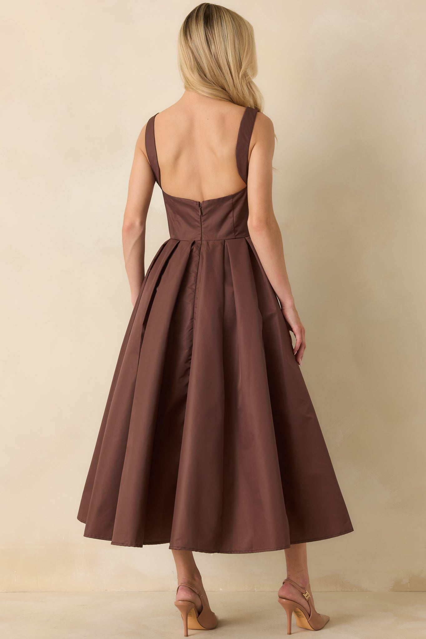 Back view of the midi dress showing deep scoop design and concealed zipper closure.