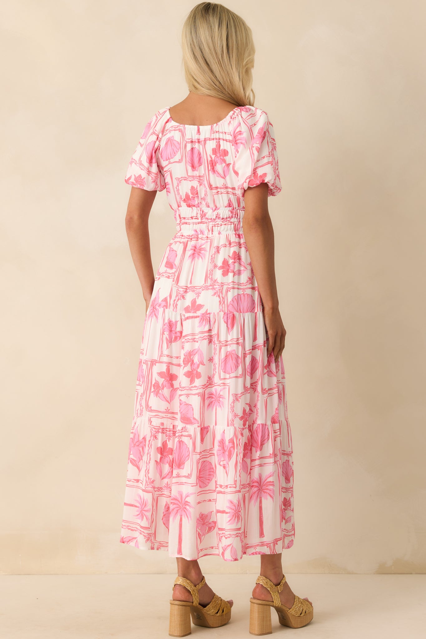 Back view of the midi dress displaying the elasticized neckline and waist, along with the continued tiered construction and lining.