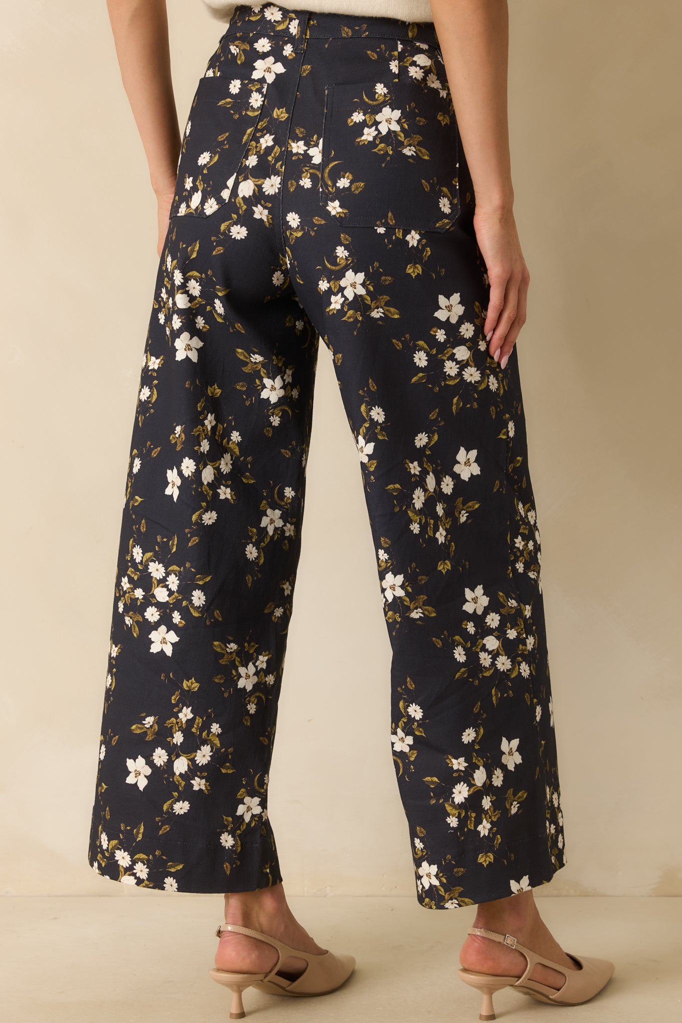 Rear view of the navy floral denim jeans with functional patch pockets and wide leg cut.