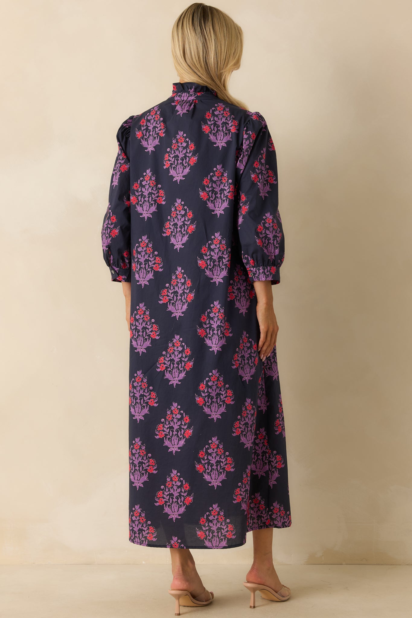 Rear view of the navy floral maxi dress showing the flowing A-line silhouette and continuous floral pattern.