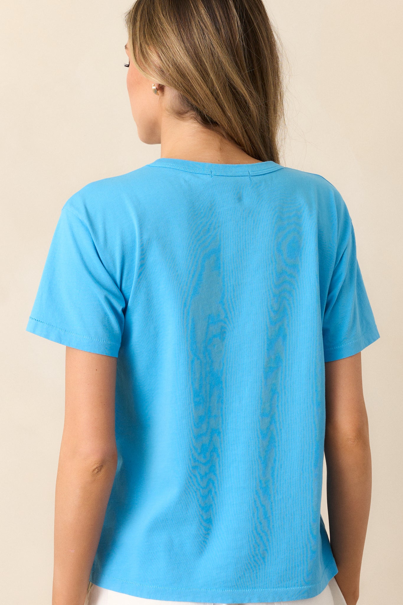 The back view of this blue tee, highlighting the clean, simple design with short sleeves and a crew neckline, perfect for a relaxed, everyday look.