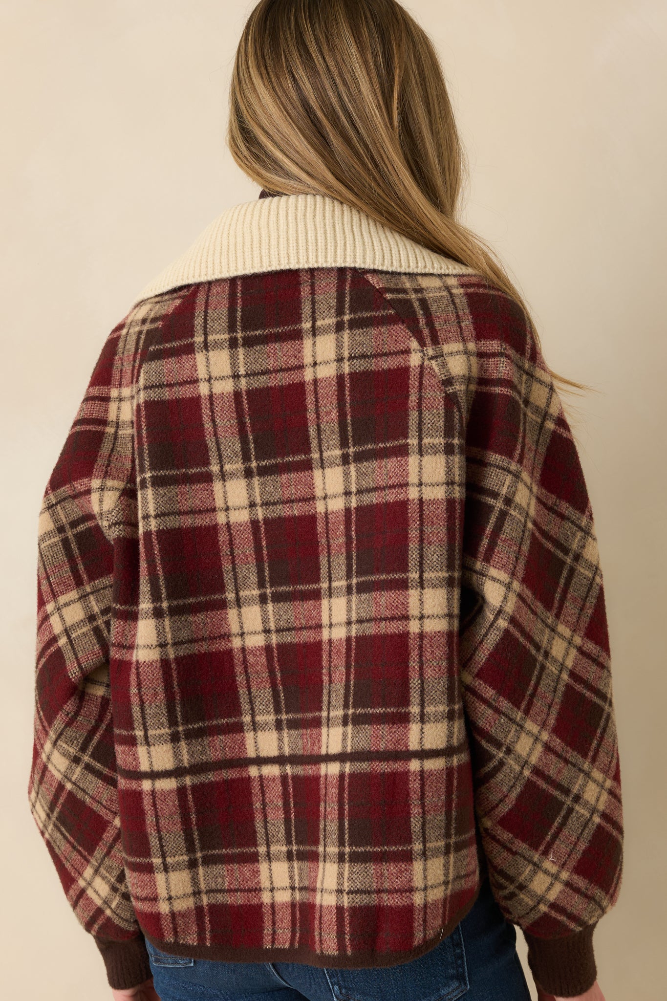 Back view of cranberry plaid jacket showing relaxed fit, back yoke, and long sleeves.