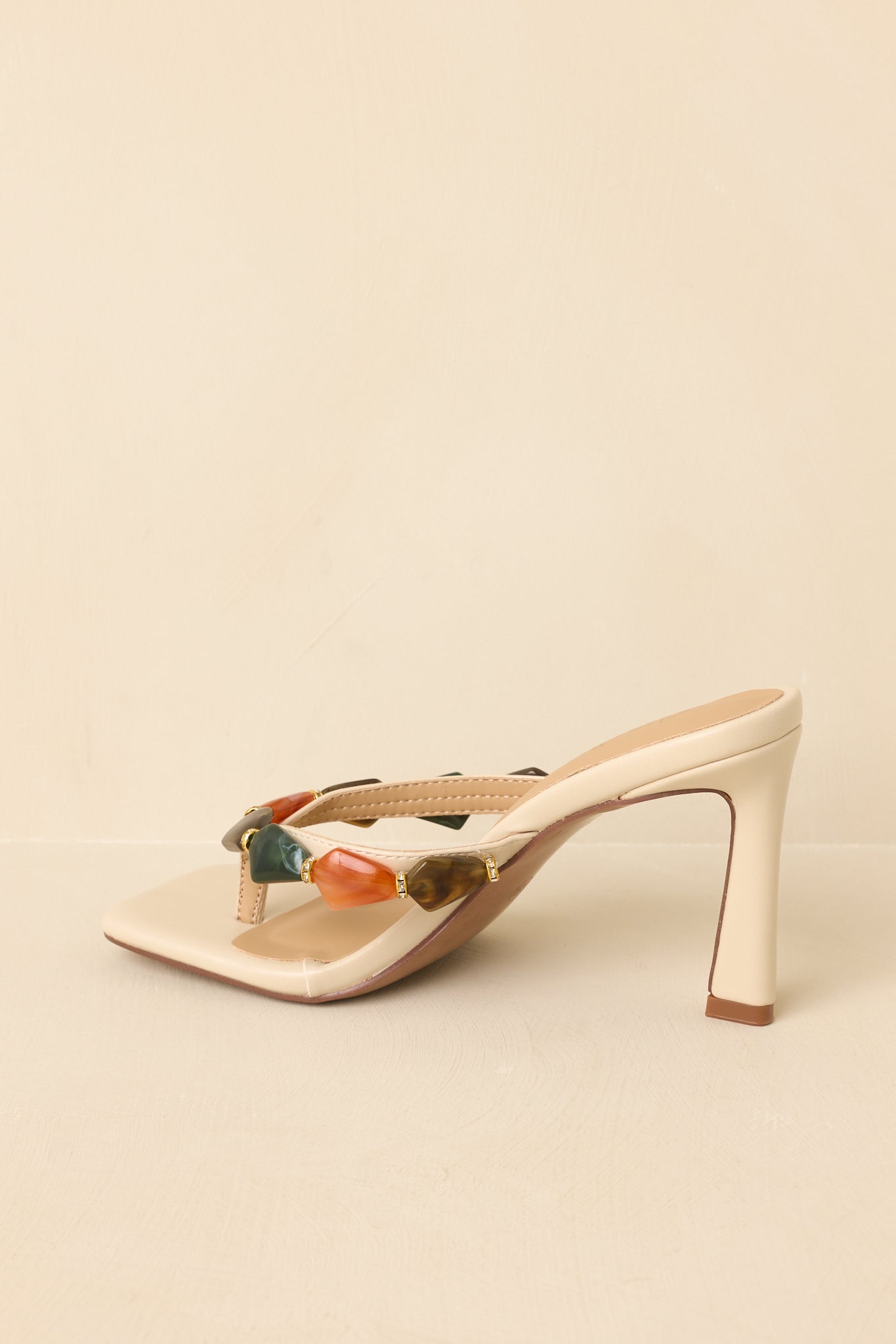 Back view of heeled sandals highlighting structured heel and minimal, streamlined design