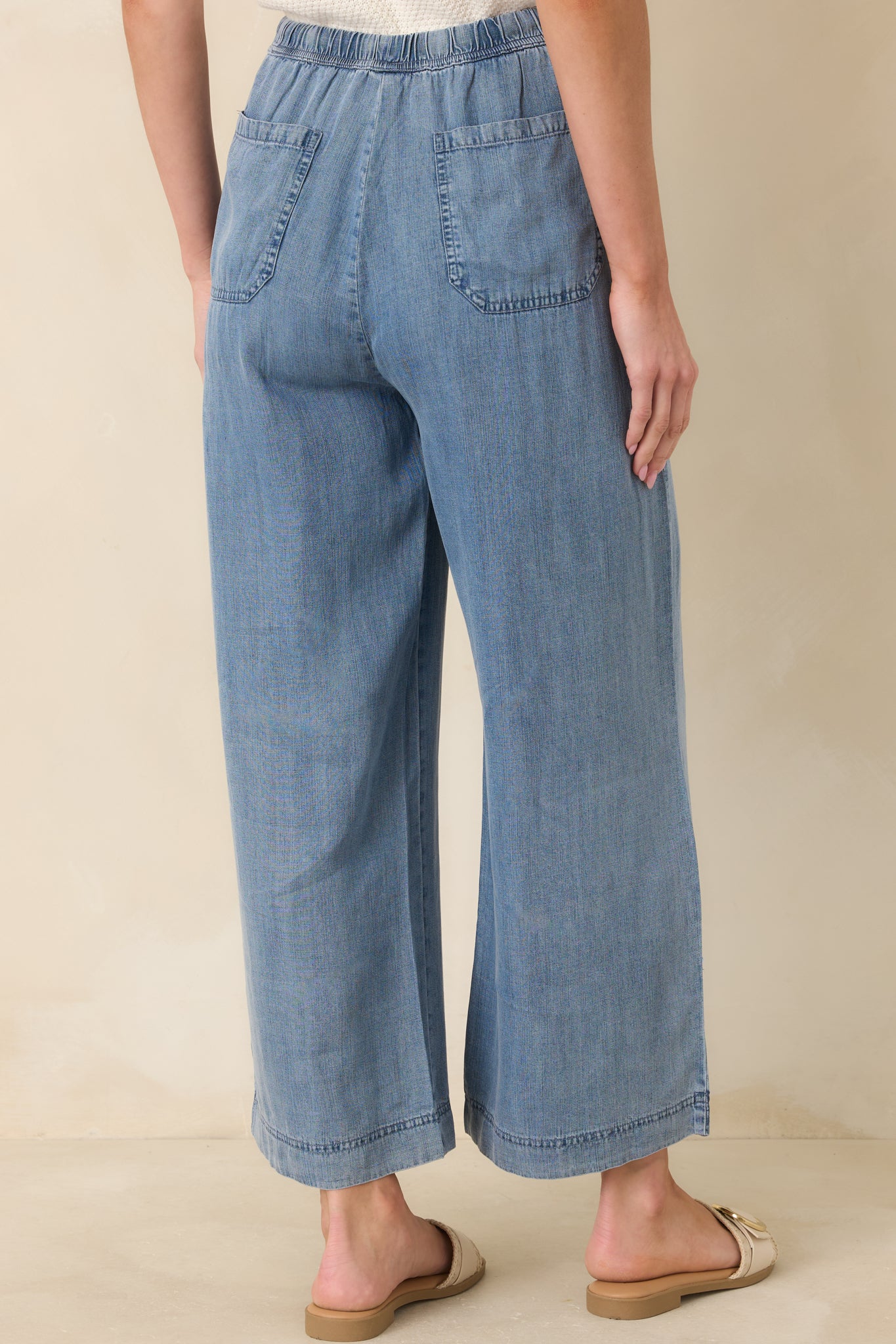 Back view of wide-leg pants with a flowing silhouette and relaxed fit.