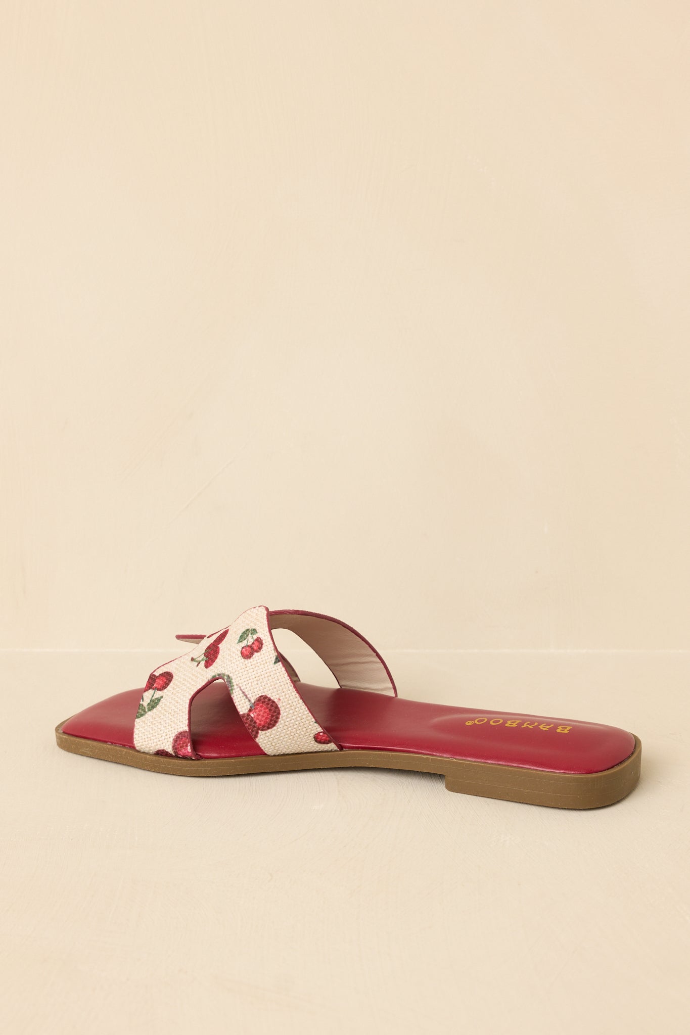 Back view of slide sandals highlighting flat sole, faux leather base, and clean, minimal heel design