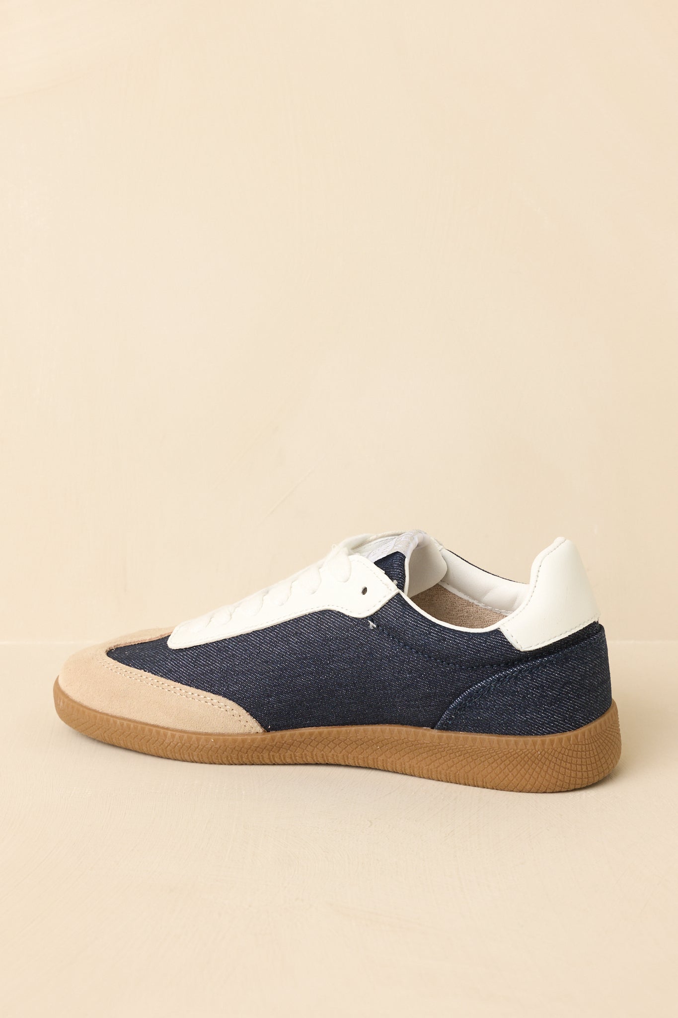Back view of sneakers showing heel design, layered construction, and textured outsole.