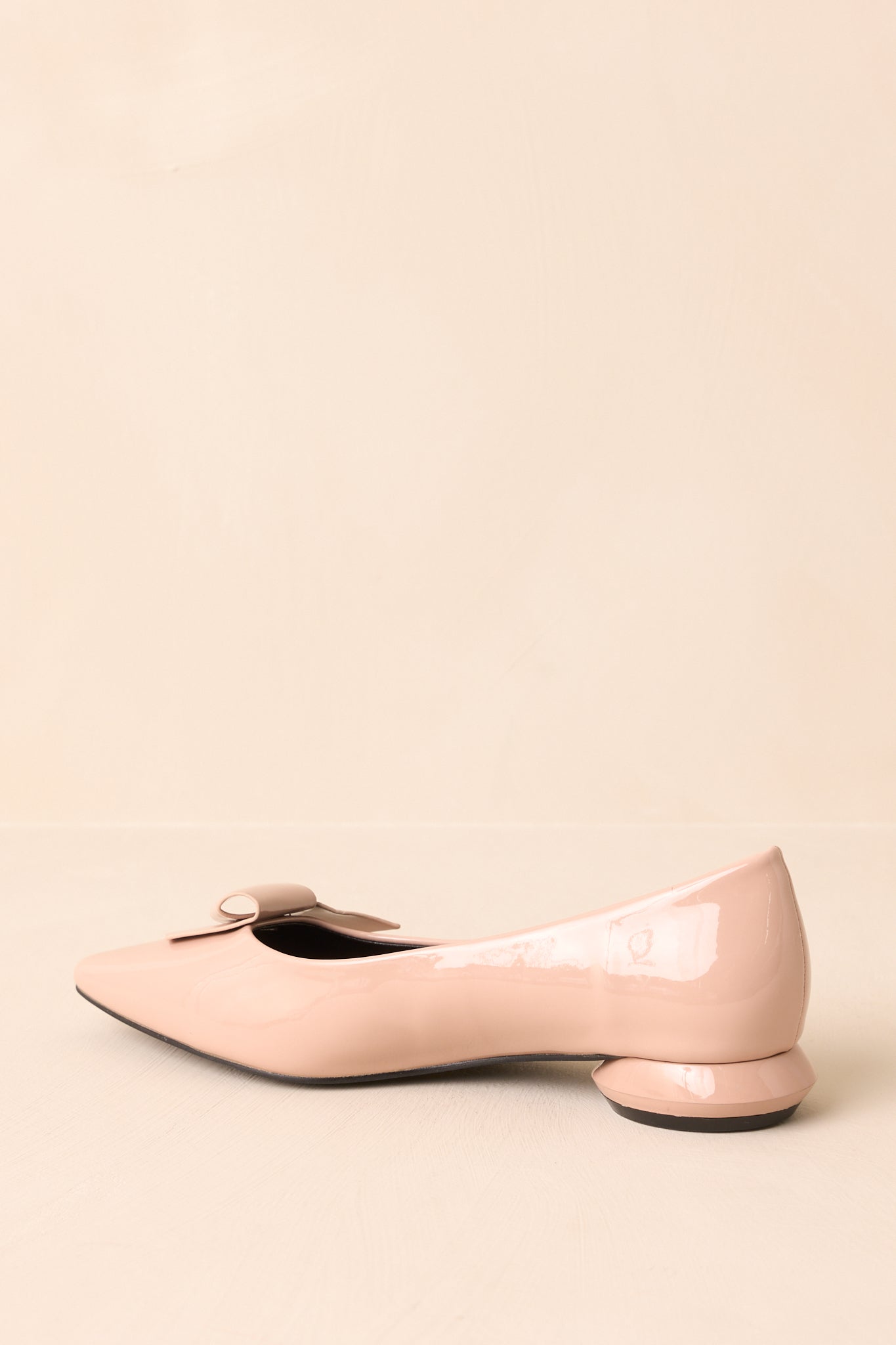 Back view of the flats showing the geometric low heel and seam detailing along the heel counter.