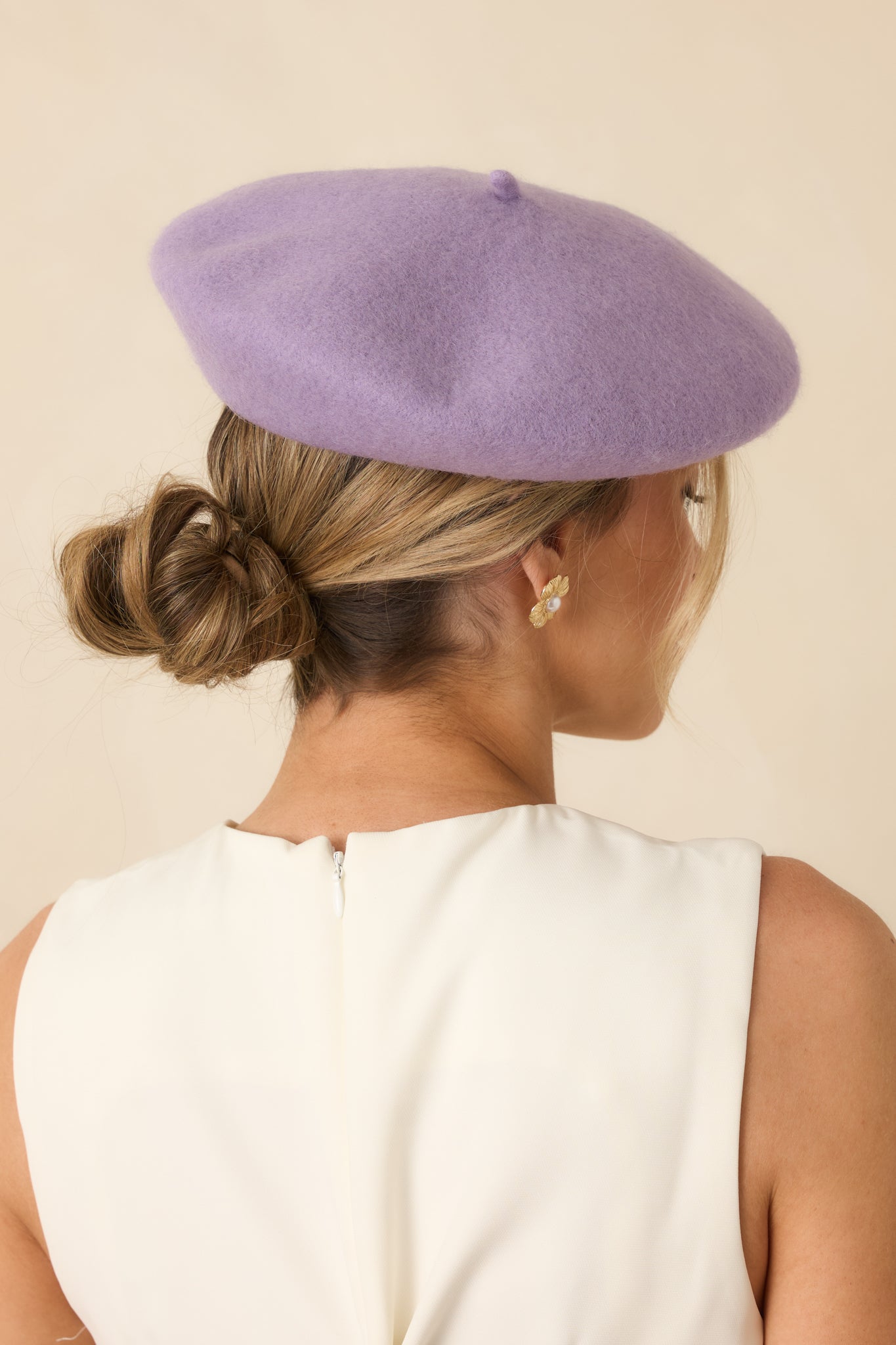Back view of the lavender beret showing the classic round silhouette and smooth wool finish.