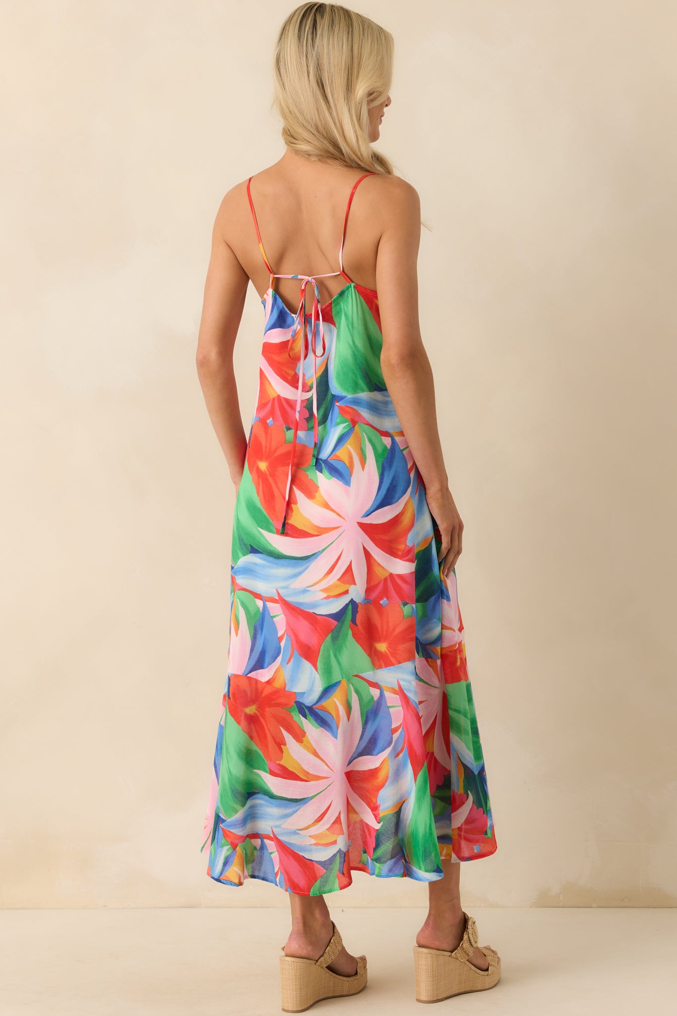 Full back view of the maxi dress showcasing the open crisscross design and how the straps adjust at the lower back.
