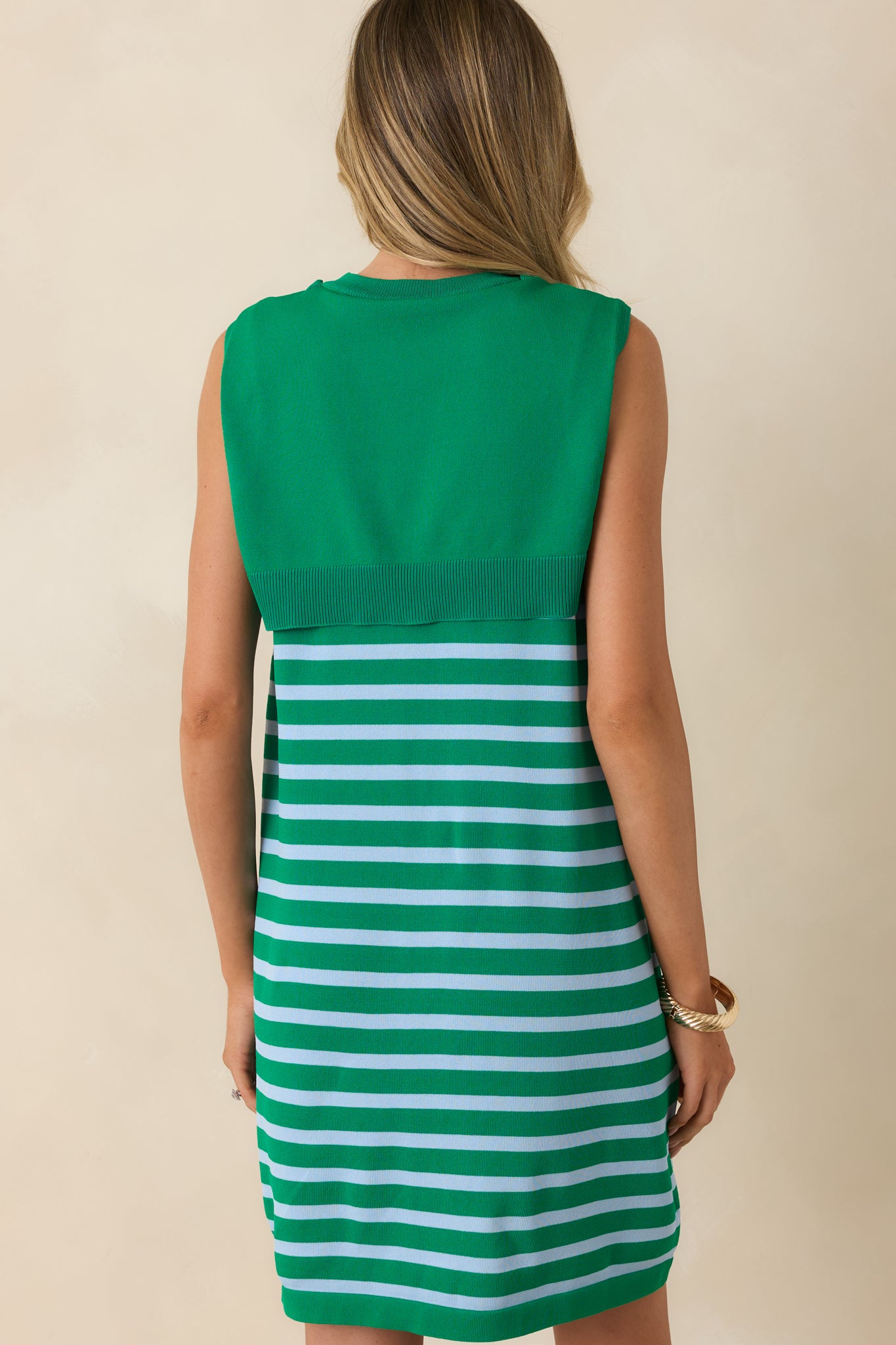 Back view of the green and light blue stripe mini dress featuring the sleeveless silhouette, soft knit body, and relaxed shift fit.