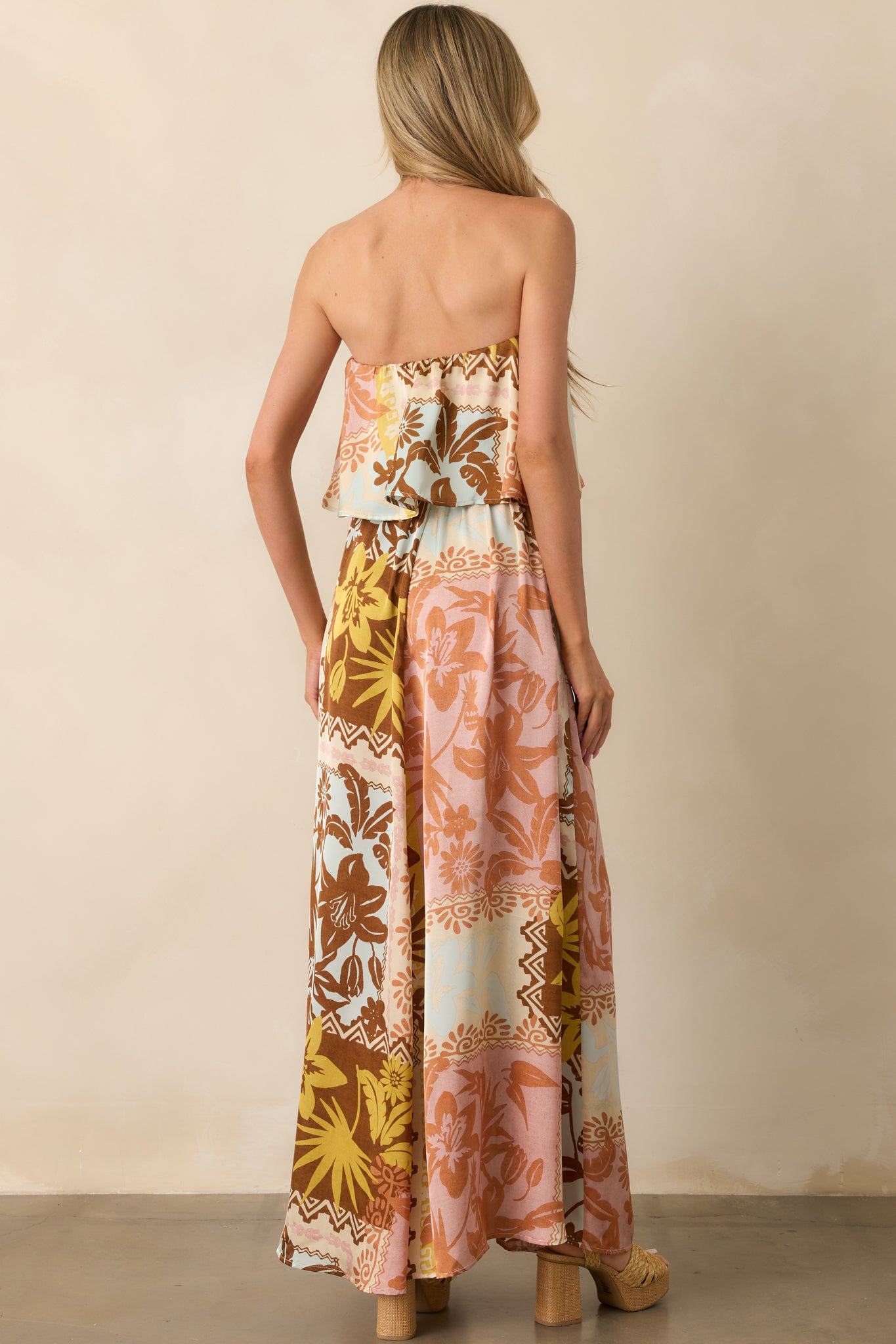 Back view of the dress displaying the strapless elastic back, the continued patchwork pattern, and the relaxed drape of the maxi skirt.