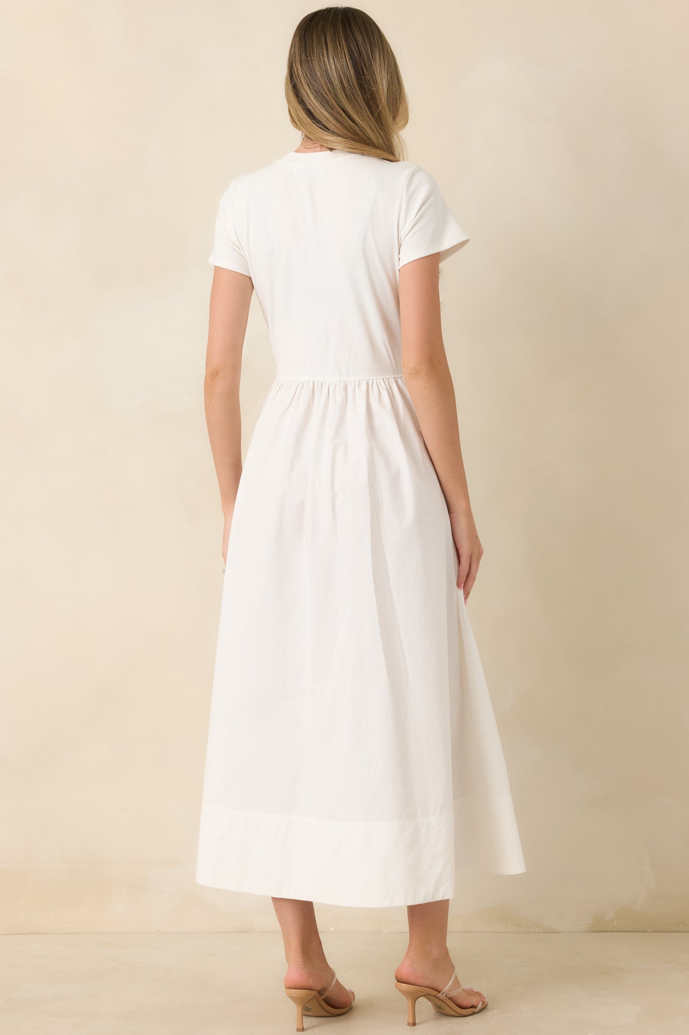 Back view of the white midi dress showcasing the fitted bodice and flowing maxi skirt.
