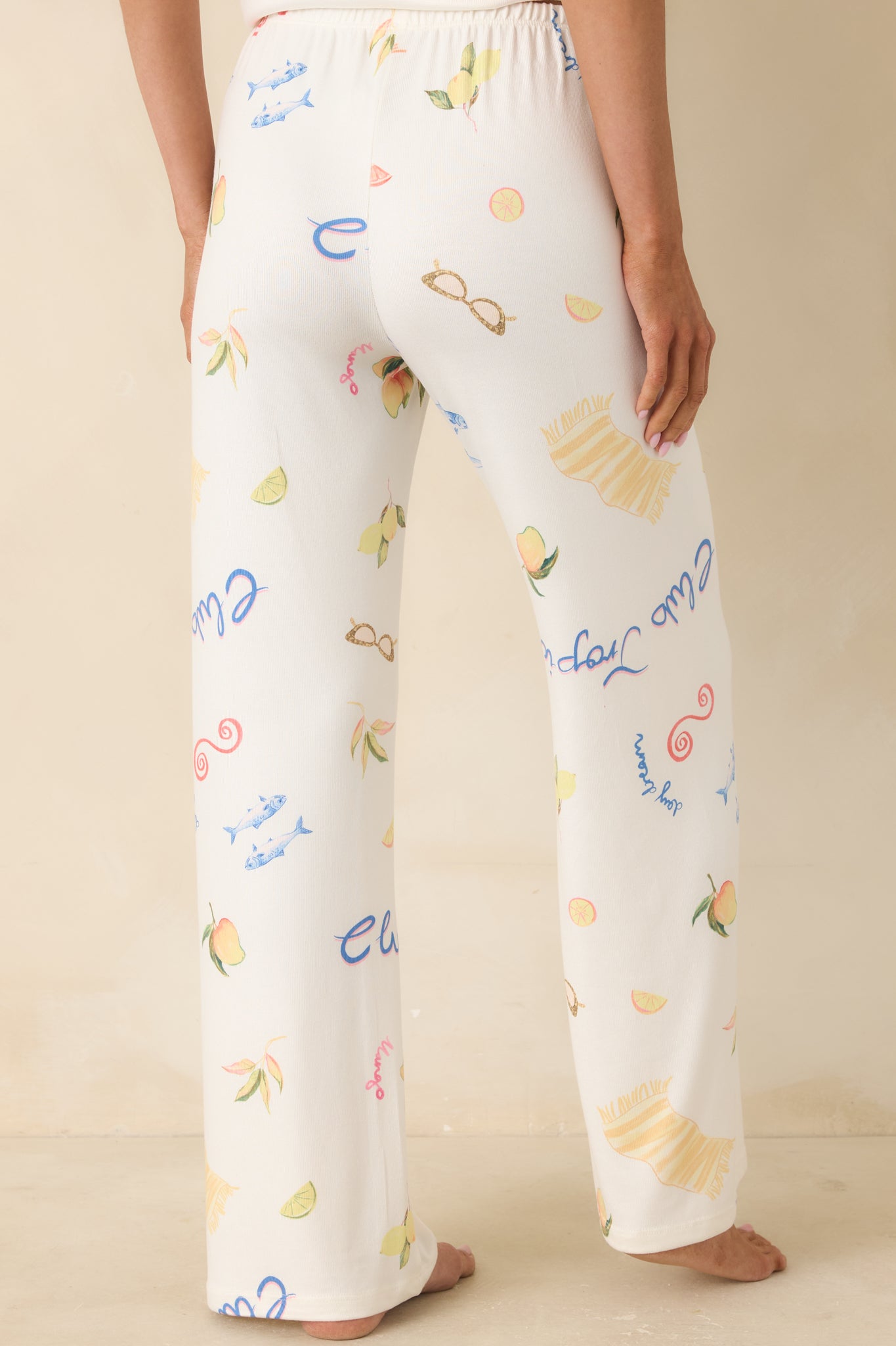 Back view of vanilla ice wide-leg pants with elastic waistband and allover vintage-inspired tropical print