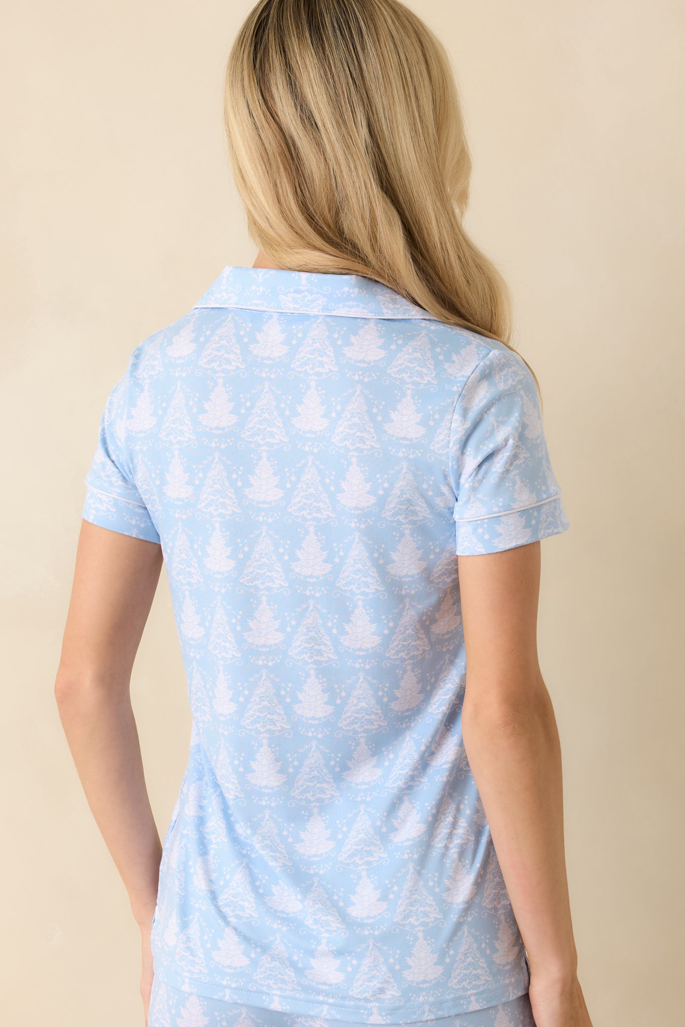 Back view of the pajama top showing the relaxed fit and continuous Christmas tree print across the back.