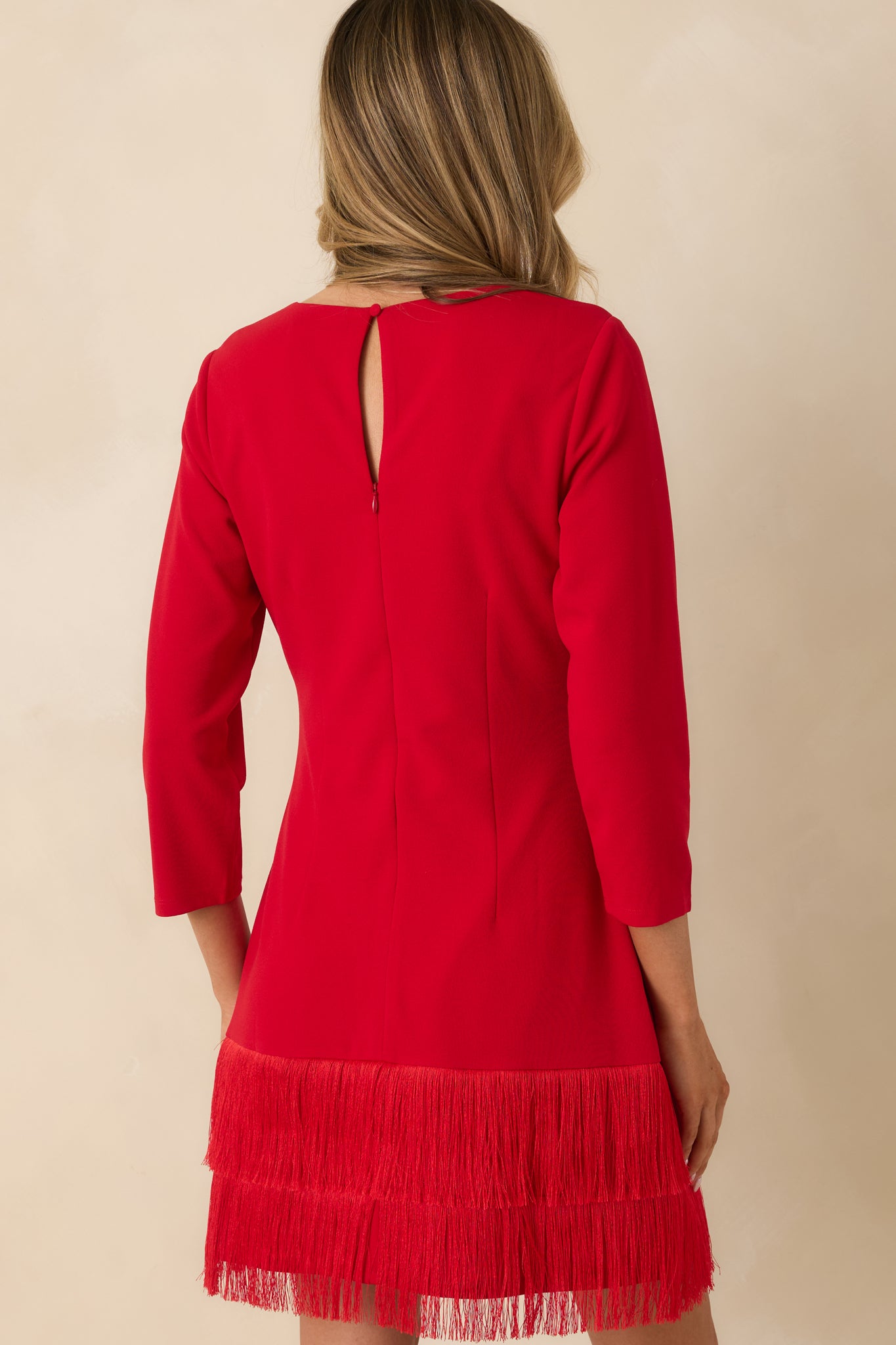 Rear of the red mini dress featuring a keyhole back with zipper closure and a fully lined interior for smooth fit.
