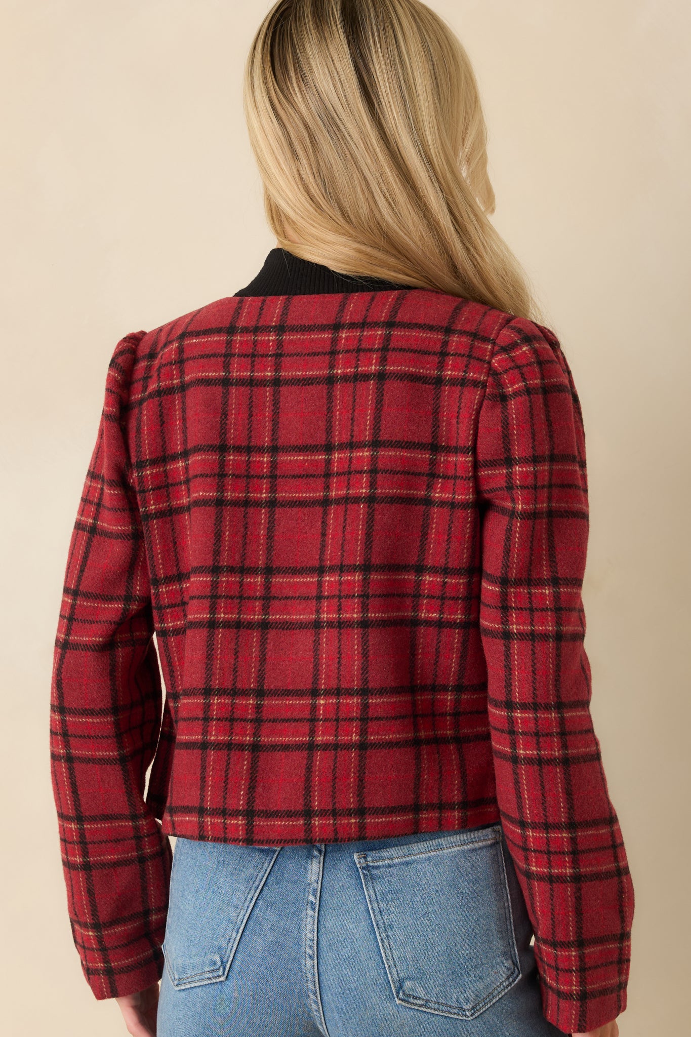 Back view of the red plaid cropped jacket showing smooth woven fabric and fitted silhouette.