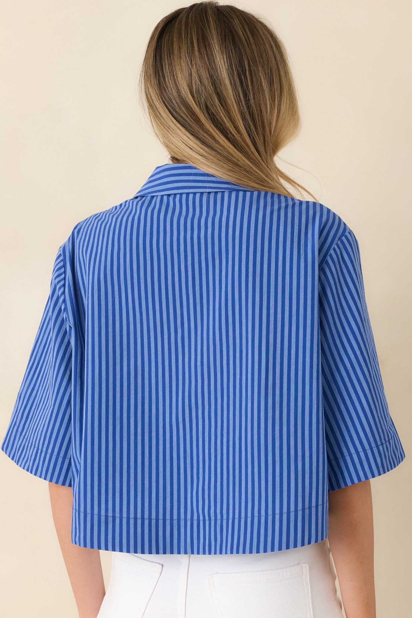 Back view of the striped cropped top showcasing the relaxed drop shoulder fit, elbow-length sleeves, and clean silhouette.