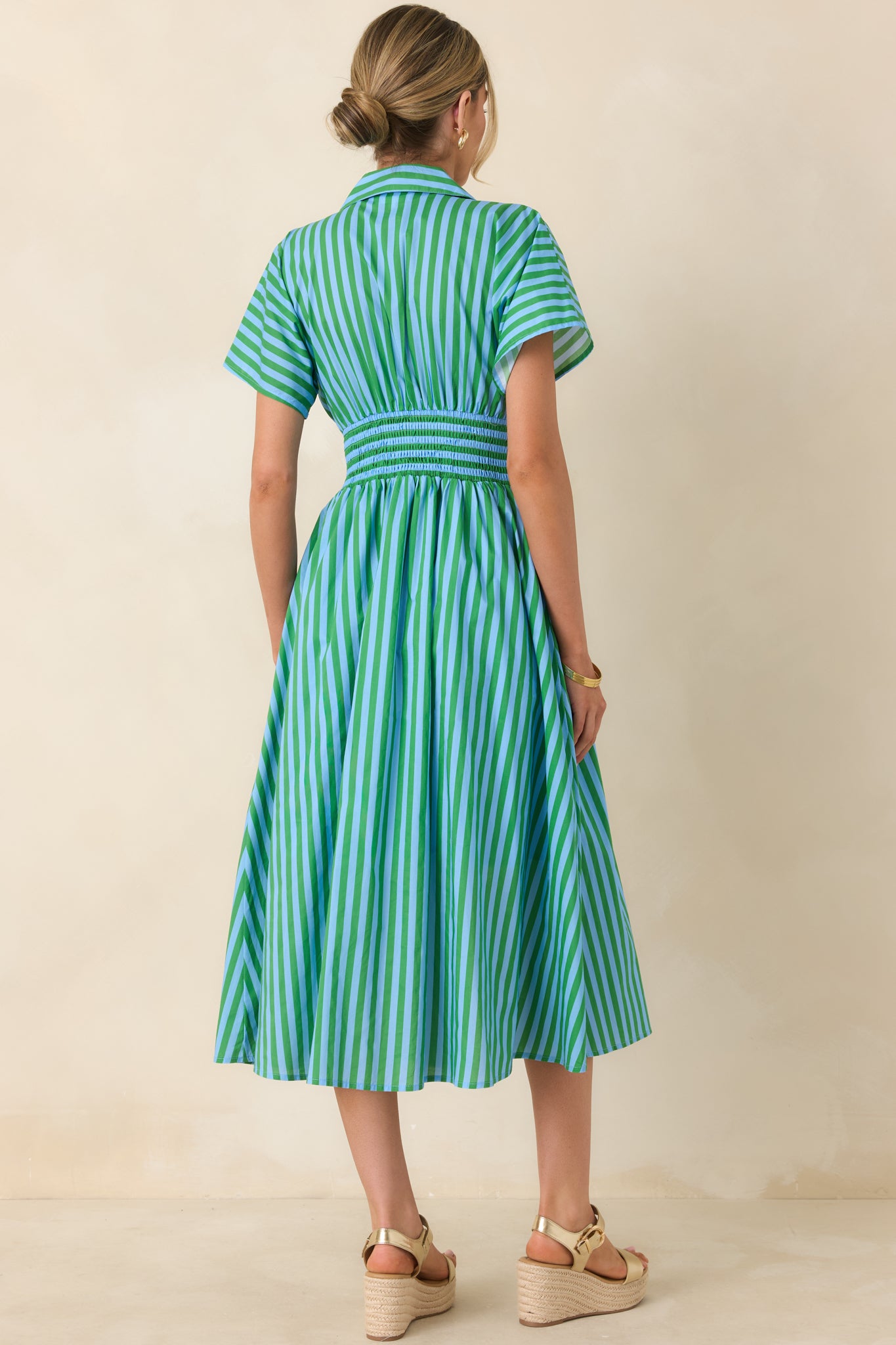 Back view of the midi dress showing the A-line skirt, short sleeves, and structured collar with smooth back silhouette.