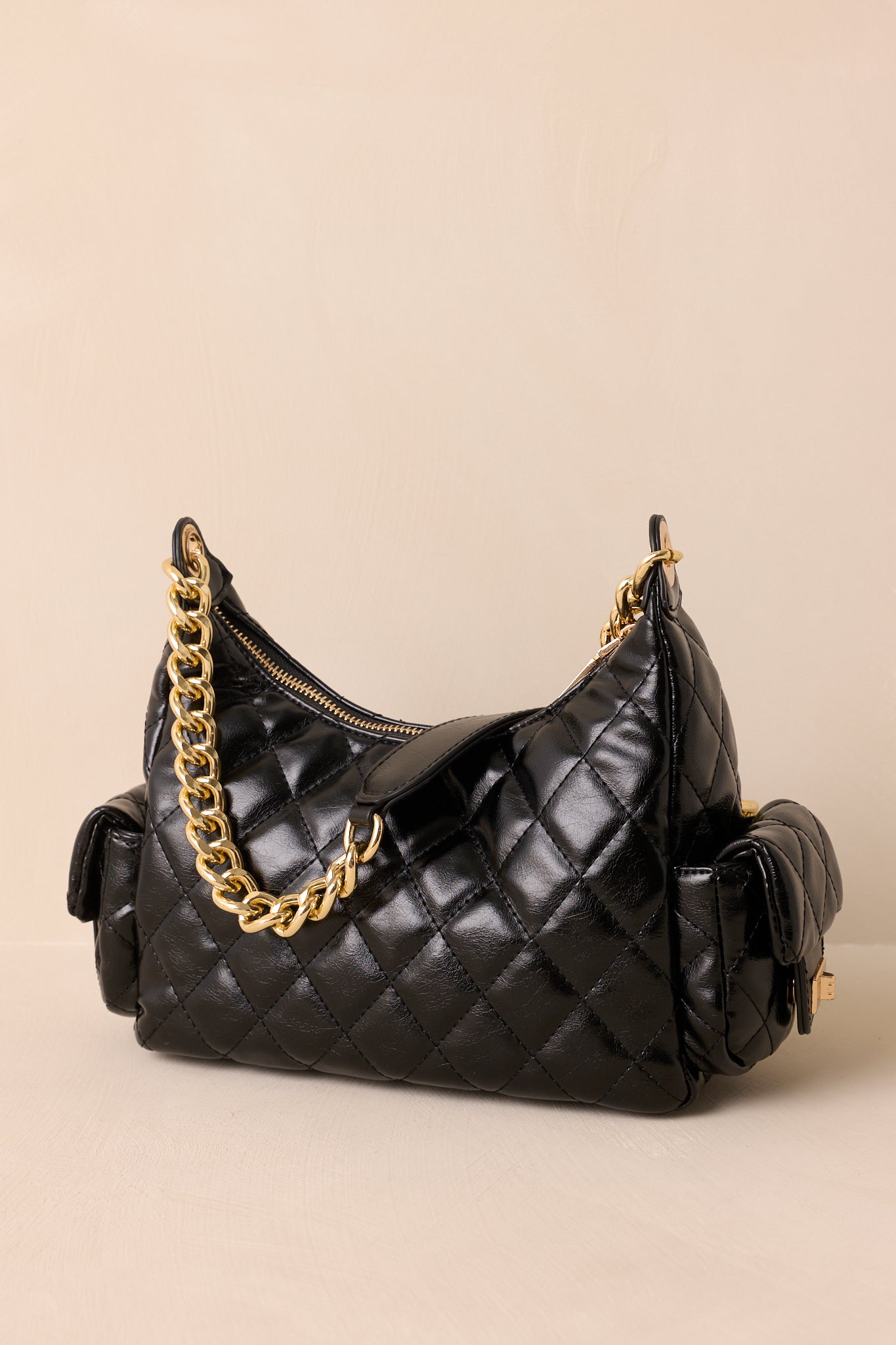 The back view of the black handbag showing the quilted faux leather material and clean structured finish.