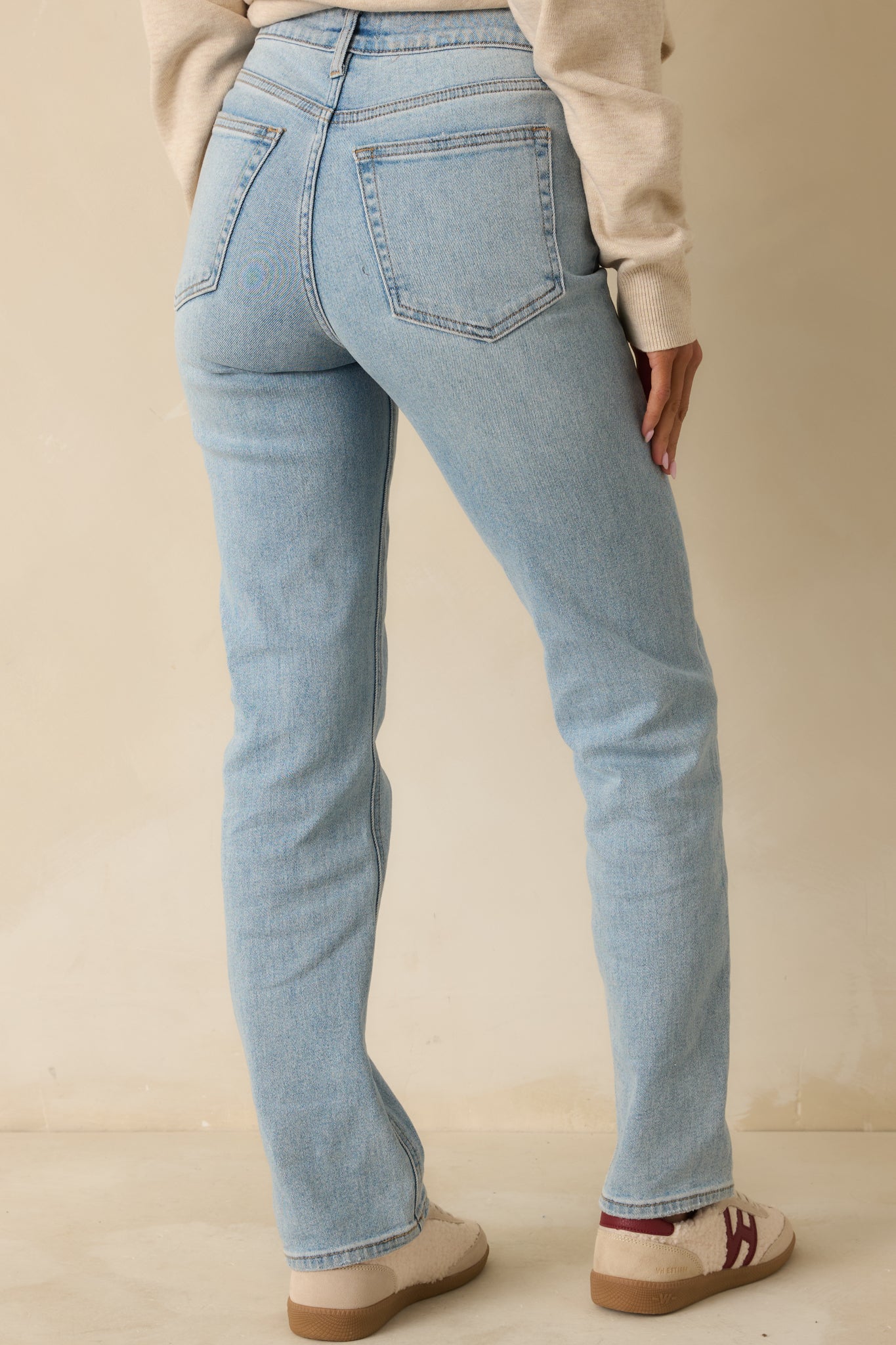 Back view of straight leg jeans showing functional back pockets and high-waisted fit across the rear waistband.