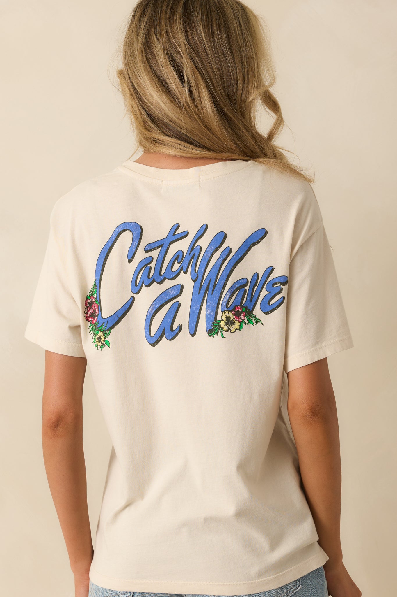 Rear view of the tee displaying the “Catch A Wave” back graphic and relaxed silhouette.