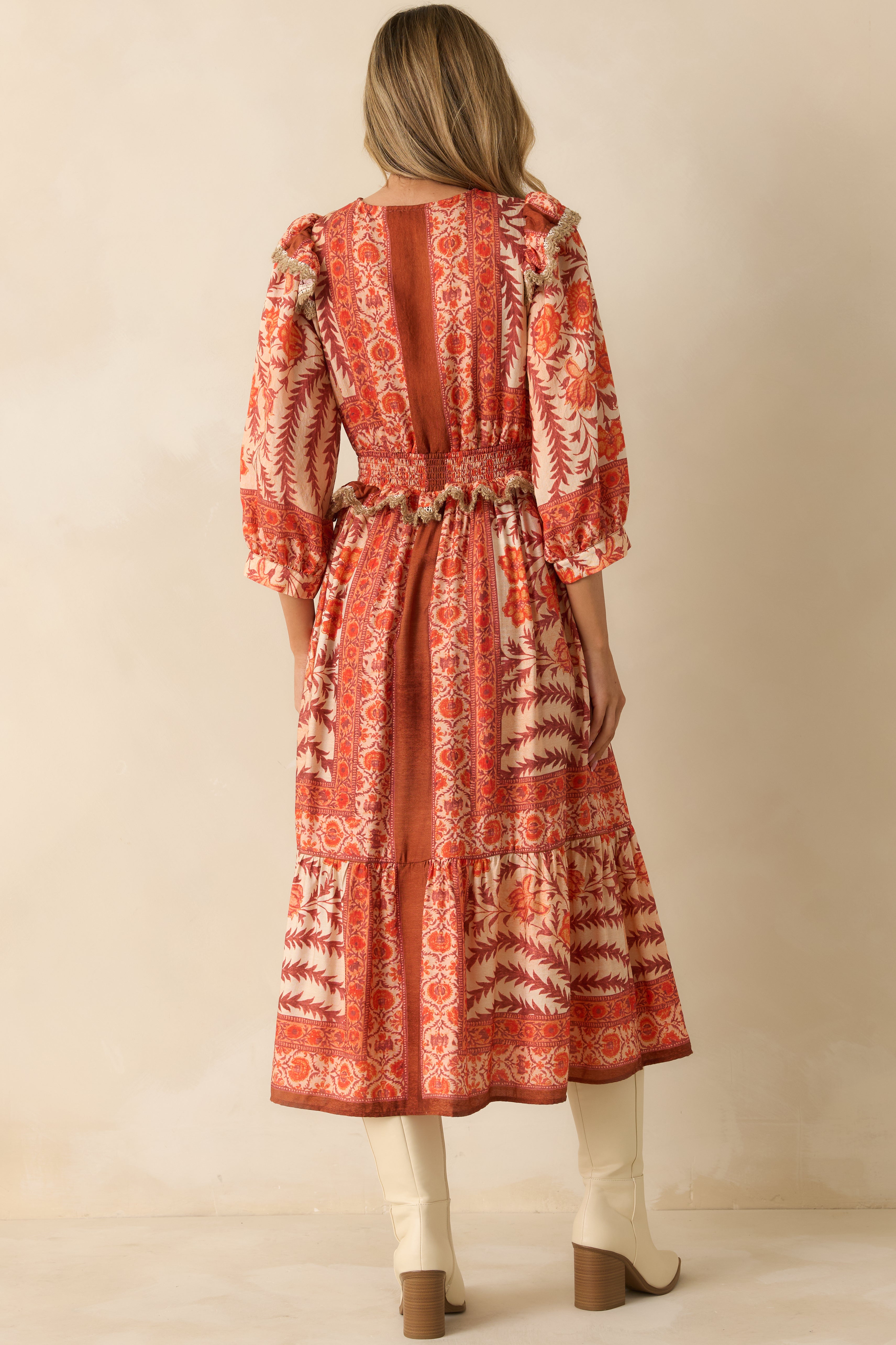 Back view capturing the overall tiered flow and vibrant patchwork print of the dress.