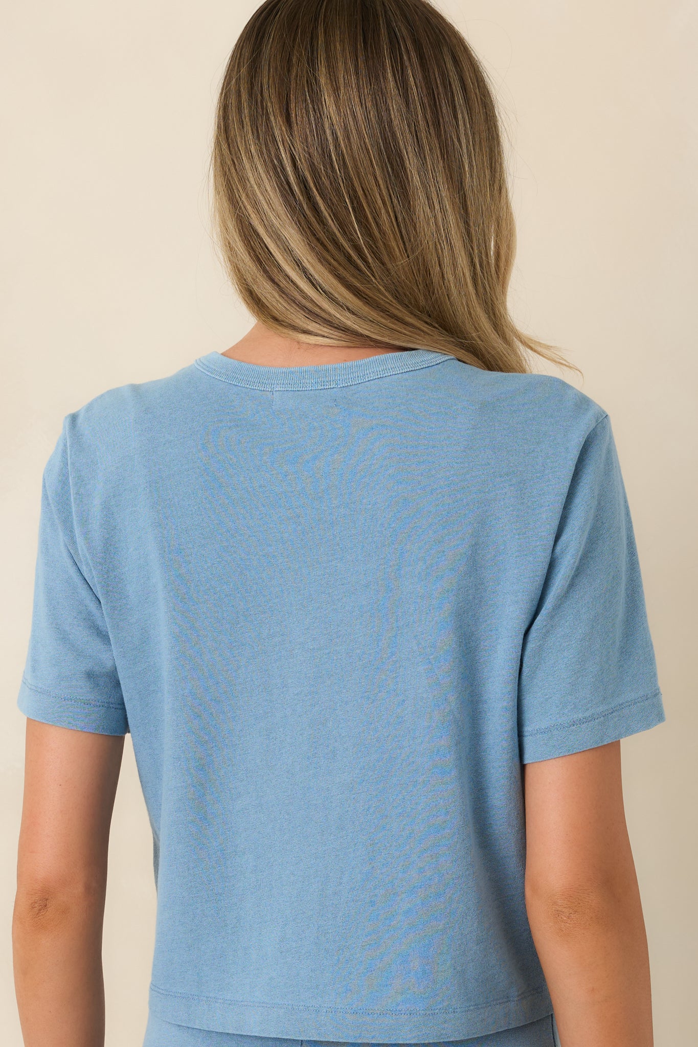 Back view of the washed indigo cotton top highlighting the relaxed fit and clean silhouette.