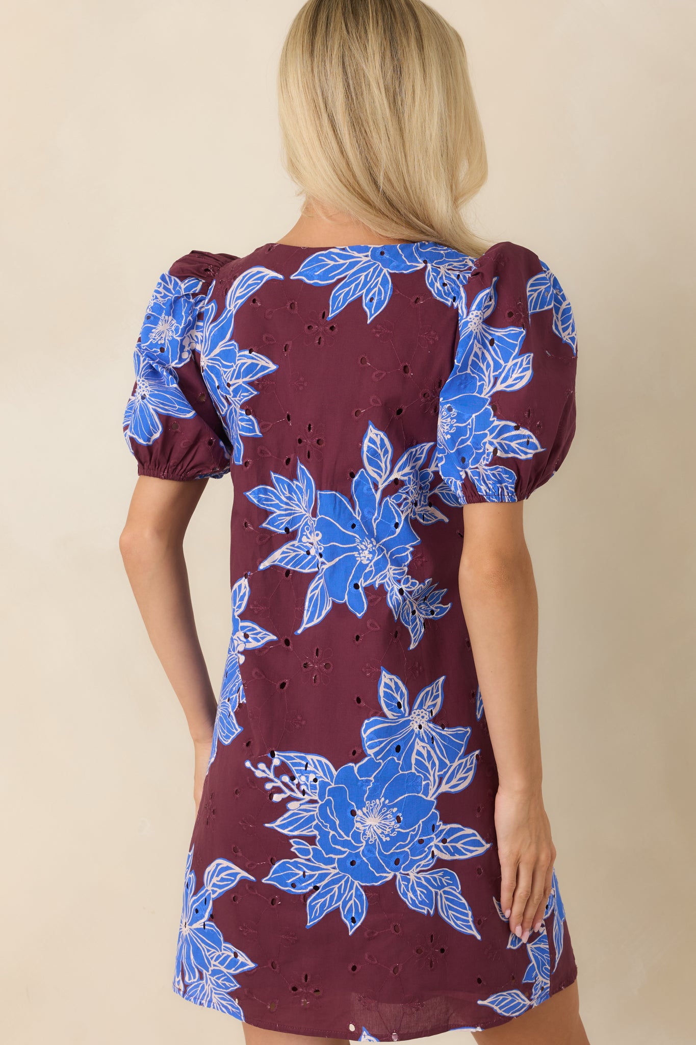 Back view of the wine red floral eyelet mini dress featuring a relaxed shift silhouette.