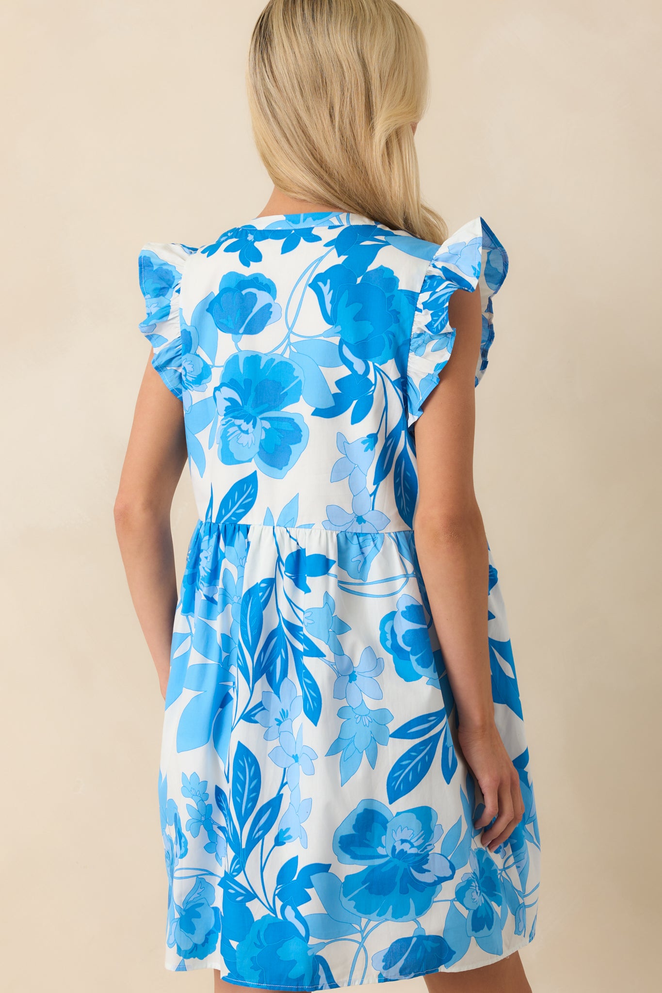 A view from behind featuring the back neckline and continued floral pattern across the dress.