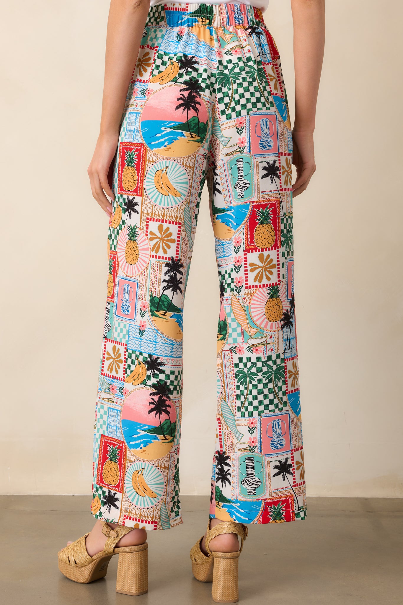A view from behind of tropical pants highlighting the back elastic waist insert and smooth upper back design.
