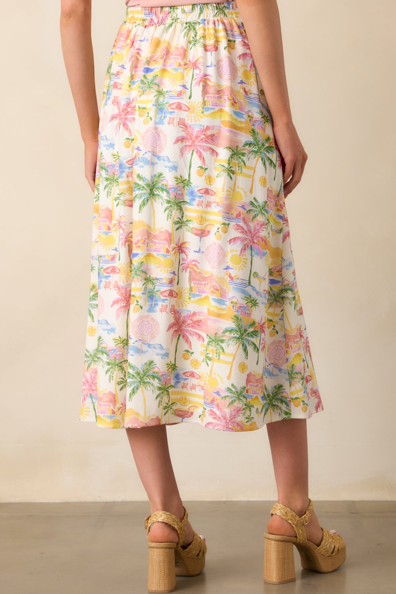 A view from behind capturing the elastic waist insert and continued tropical print across the back of the skirt.
