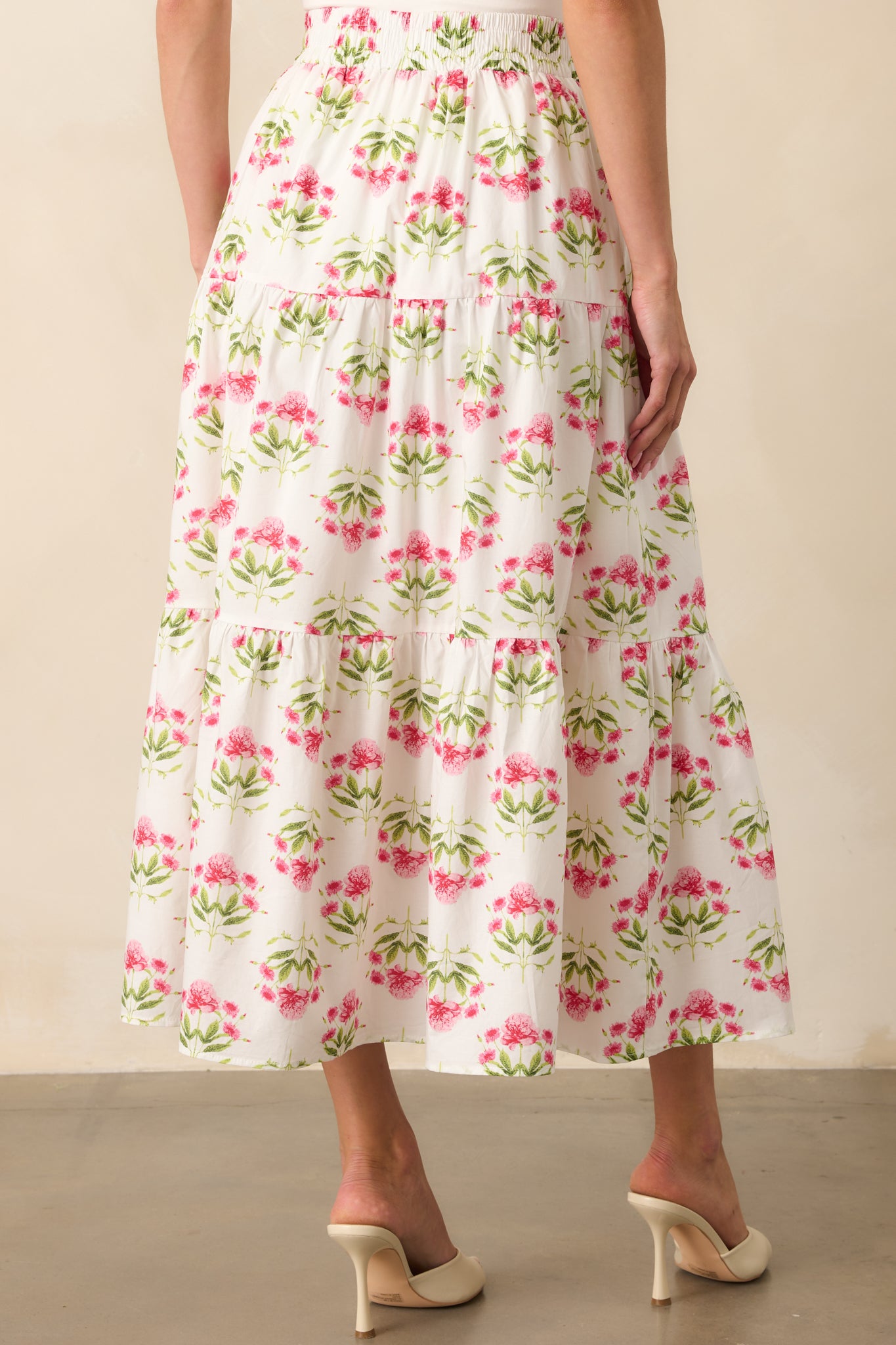 A view from behind of the floral maxi skirt, displaying the tiered construction and continued smocked waistband.