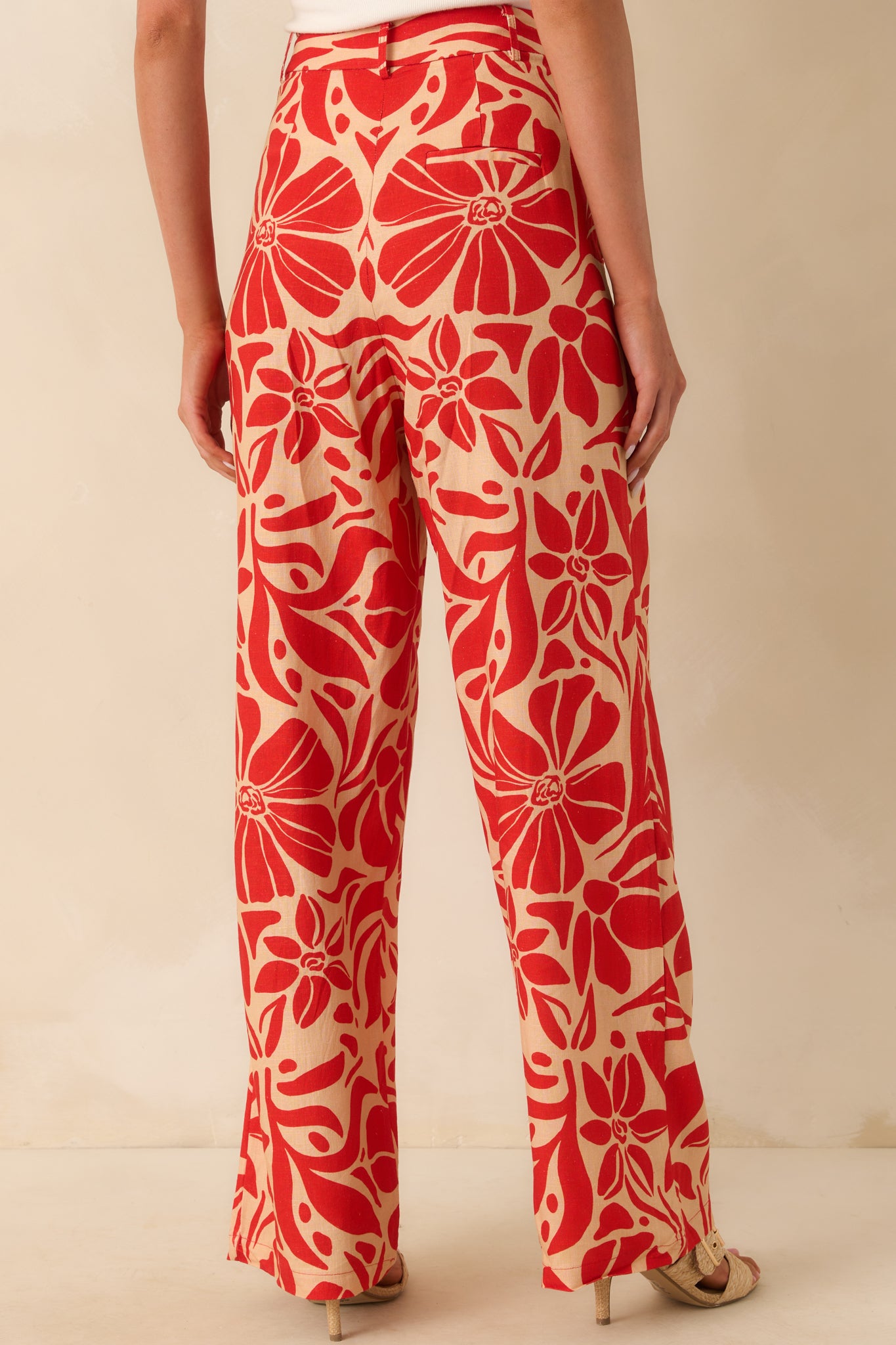  A view from behind showing the faux slit pocket and continuous floral print across the back of the pants.