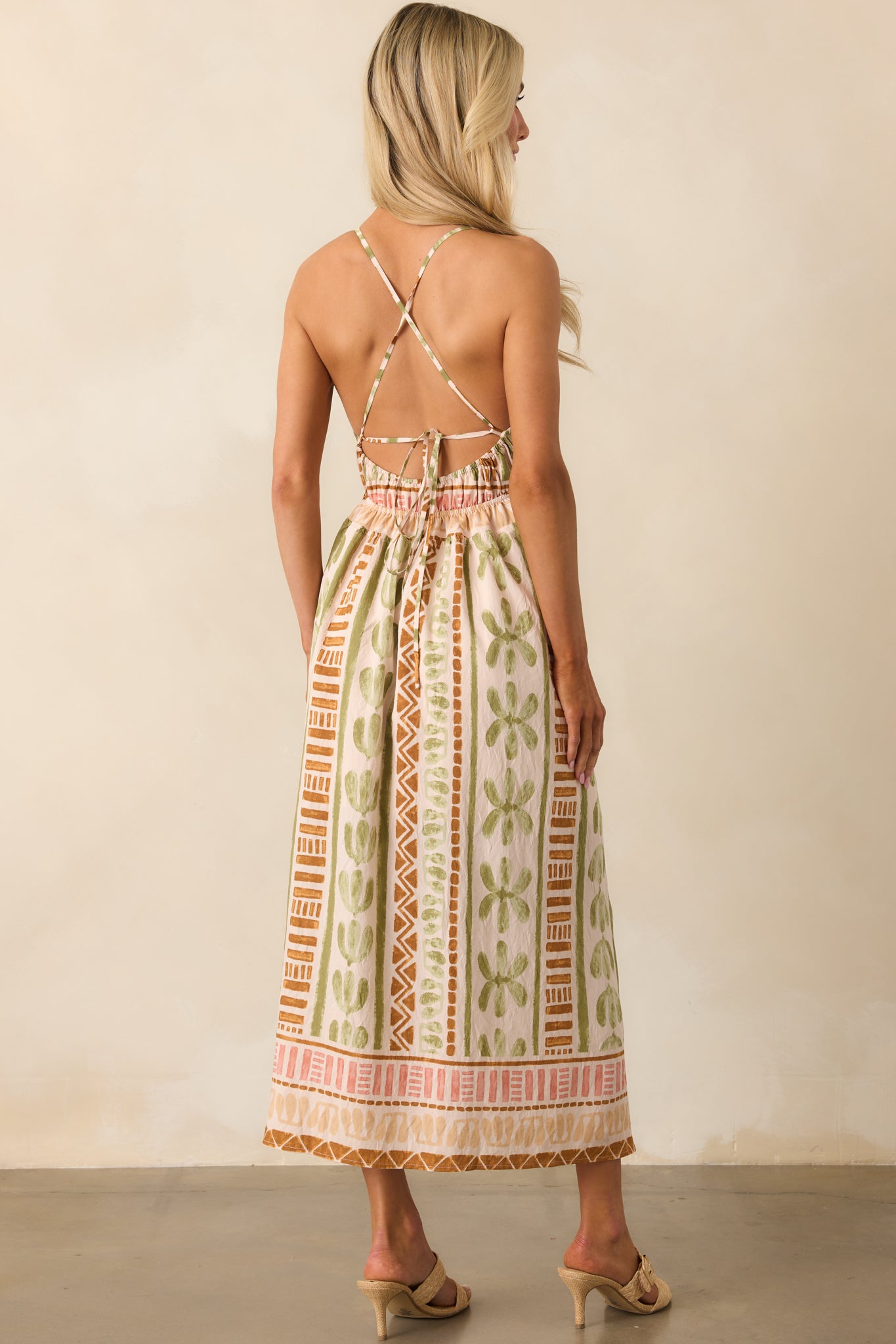 A view from behind showing the open lace-up back, adjustable ties, and overall print alignment of the maxi dress.